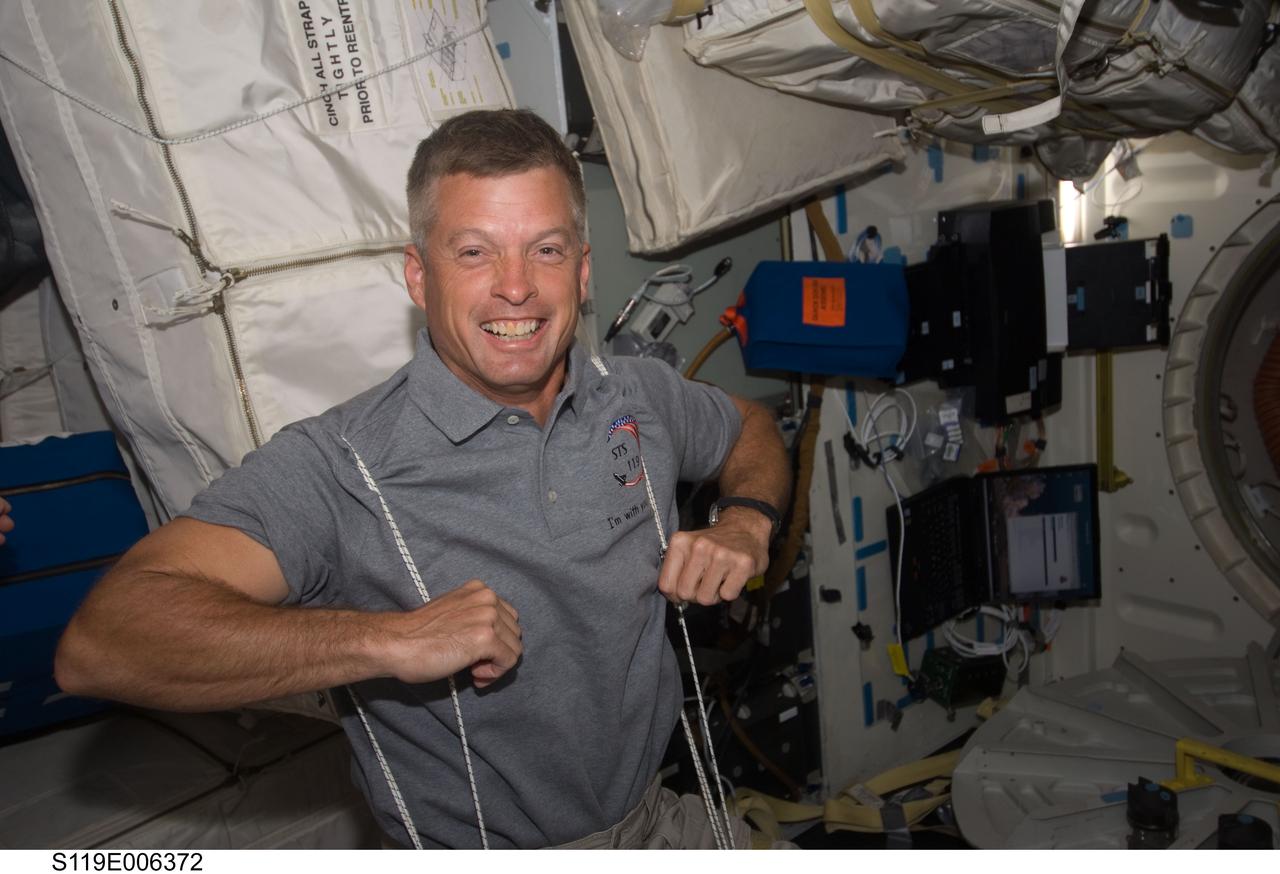 S119-E-006372 (17 March 2009) --- Astronaut Steve Swanson, STS-119 mission specialist, exercises on the middeck of Space Shuttle Discovery.