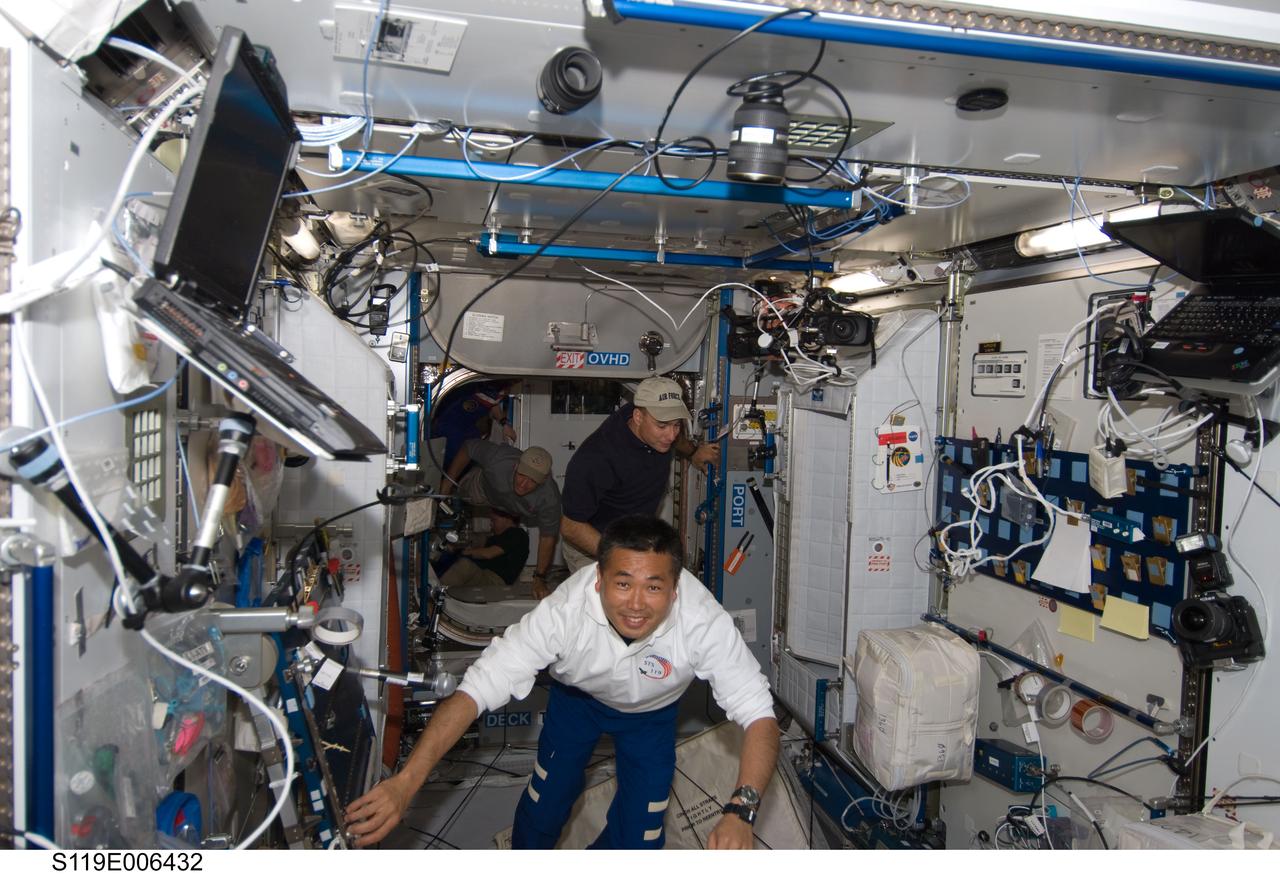 S119-E-006432 (17 March 2009) --- Japan Aerospace Exploration Agency (JAXA) astronaut Koichi Wakata (foreground), STS-119 mission specialist; NASA astronauts Lee Archambault, commander; Steve Swanson and Joseph Acaba, both mission specialists, enter the Harmony node shortly after Space Shuttle Discovery and the International Space Station docked in space and the hatches were opened on March 17, 2009. STS-119 crewmembers not pictured are astronauts Tony Antonelli, pilot; Richard Arnold and John Phillips, both mission specialists.