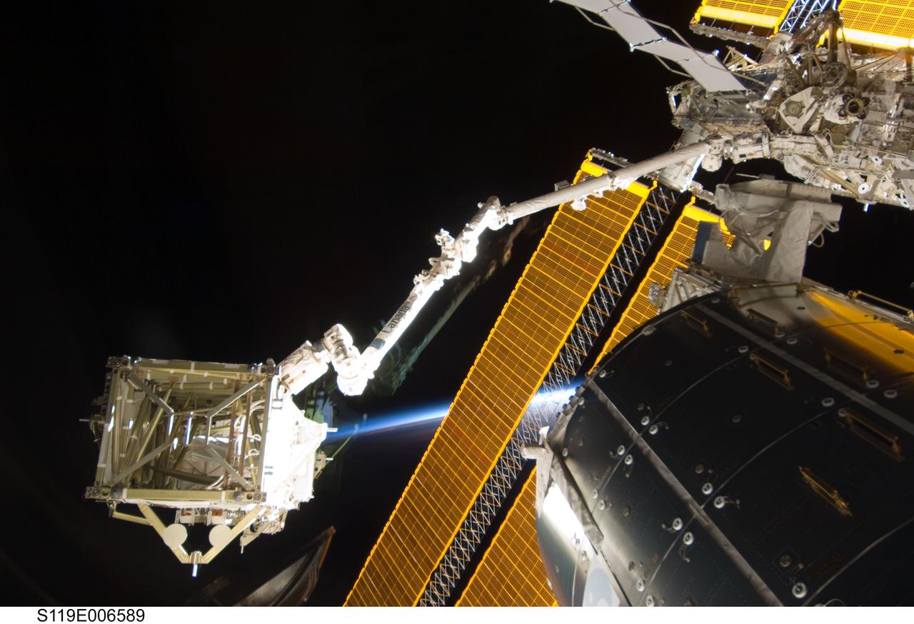 S119-E-006589 (18 March 2009) --- In the grasp of the International Space Station’s robotic Canadarm2, the S6 truss segment was photographed by a STS-119 crewmember while Space Shuttle Discovery is docked with the station. The S6 truss segment was moved from Discovery’s cargo bay by the station’s Canadarm2, handed off to the shuttle’s remote manipulator system (RMS), and then handed back to the station’s robotic arm where it will remain in an overnight parked position. Also visible in the image are the Columbus laboratory, starboard truss and solar array panels.
