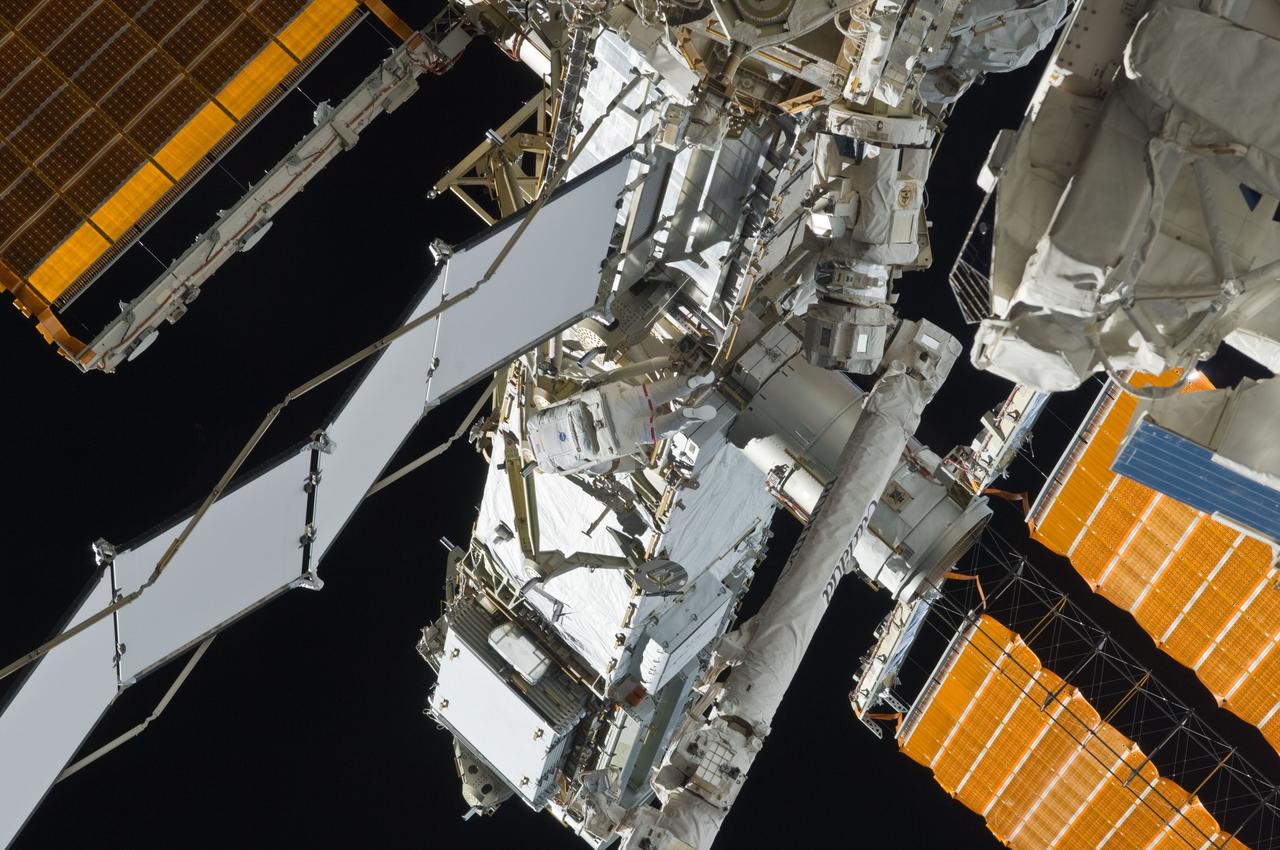 S119-E-006674 (19 March 2009) --- Astronaut Steve Swanson (center), STS-119 mission specialist, participates in the mission's first scheduled session of extravehicular activity (EVA) as construction and maintenance continue on the International Space Station. During the six-hour, seven-minute spacewalk, Swanson and astronaut Richard Arnold (out of frame), mission specialist, connected bolts to permanently attach the S6 truss segment to S5. The spacewalkers plugged in power and data connectors to the truss, prepared a radiator to cool it, opened boxes containing the new solar arrays and deployed the Beta Gimbal Assemblies containing masts that support the solar arrays.