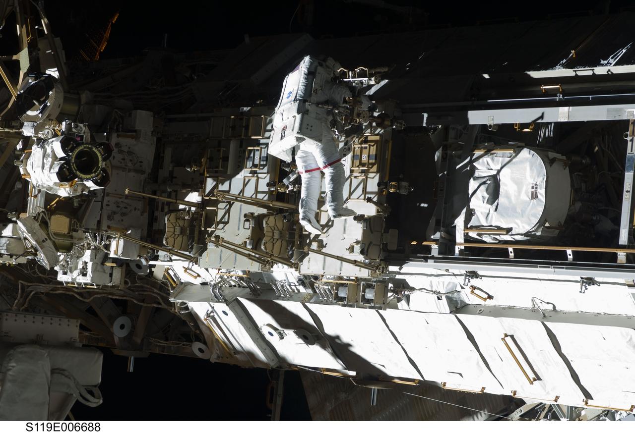 S119-E-006688 (19 March 2009) --- Astronaut Steve Swanson, STS-119 mission specialist, participates in the mission's first scheduled session of extravehicular activity (EVA) as construction and maintenance continue on the International Space Station. During the six-hour, seven-minute spacewalk, Swanson and astronaut Richard Arnold (out of frame), mission specialist, connected bolts to permanently attach the S6 truss segment to S5. The spacewalkers plugged in power and data connectors to the truss, prepared a radiator to cool it, opened boxes containing the new solar arrays and deployed the Beta Gimbal Assemblies containing masts that support the solar arrays.
