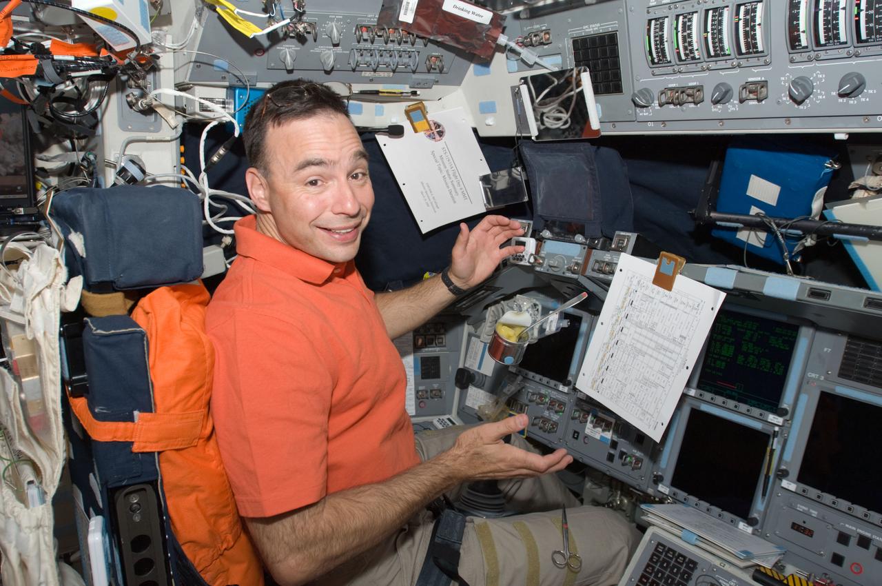 S119-E-006690 (20 March 2009) --- On the eve of his mission's second extravehicular activity, astronaut Lee Archambault finds himself temporarily back in the commander's seat aboard the Space Shuttle Discovery.  With more than five days in space under its belt, the STS-119 crew has shuffled back and forth between the shuttle and the International Space Station as the home improvement project on the orbital outpost continues, including the successful initial spacewalk on March 19.  Two astronauts from the STS-119 crew will leave through the station's airlock on March 21 to perform the second of three scheduled spacewalks.