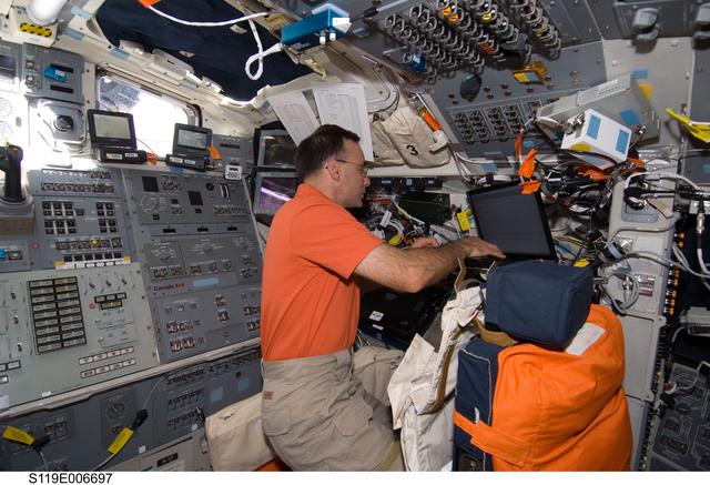 NASA image: Archambault at Laptop on AFT Flight Deck (FD)