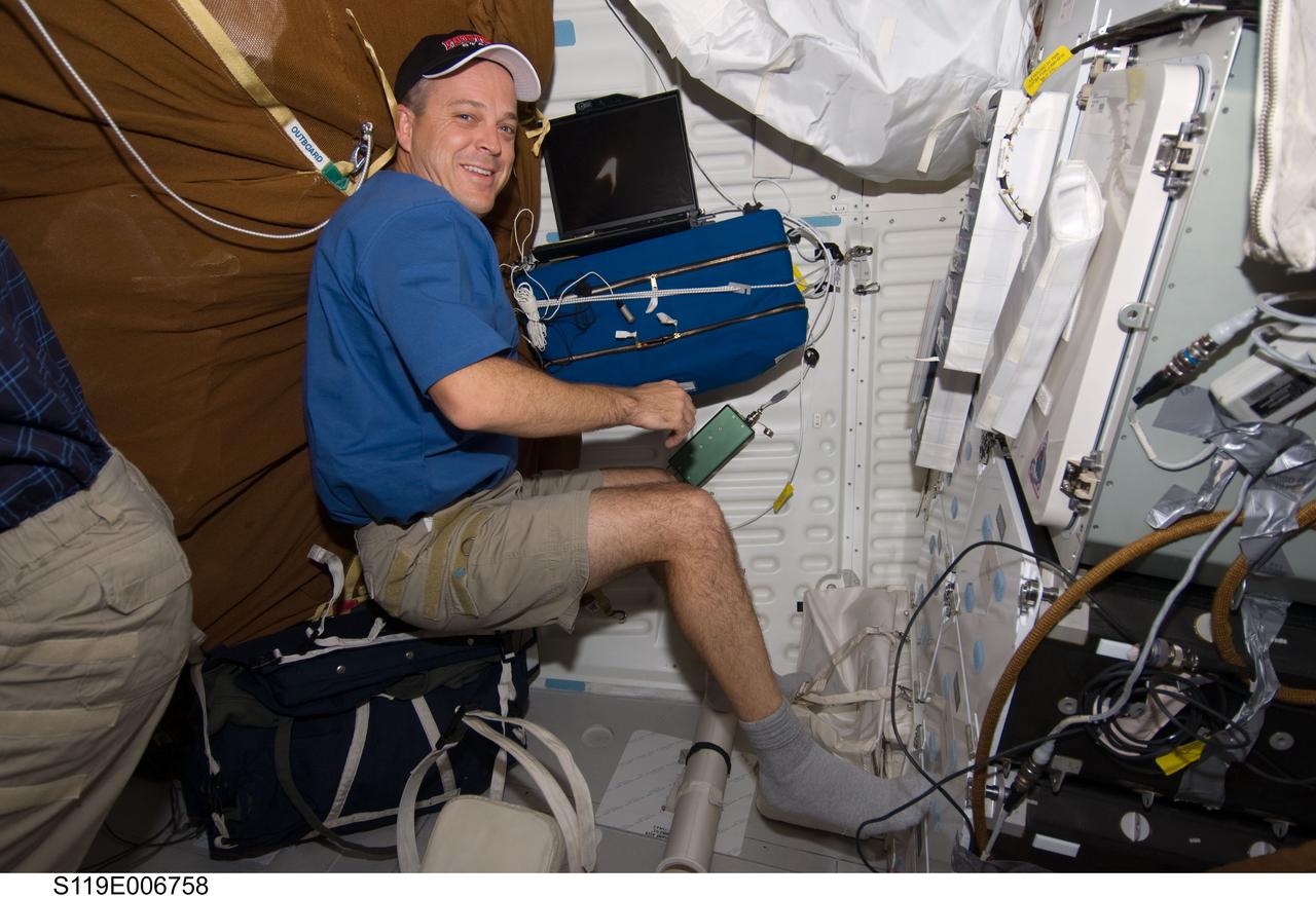 S119-E-006758 (20 March 2009) --- Astronaut Richard Arnold, STS-119 mission specialist, (pictured on the mid deck), and other members of the Discovery crew, along with the two astronauts and a cosmonaut crew member of ISS-018, are looking forward to supporting the second spacewalk during this linkup. Arnold participated in the first extravehicular activity, March 19, as he joined astronaut Steve Swanson outside the confines of the orbiting complex to perform a variety of tasks.