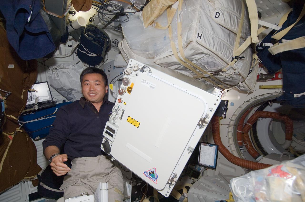 S119-E-006764 (20 March 2009) --- Japan Aerospace Exploration Agency astronaut Koichi Wakata is pictured on Discovery's middeck with the General Laboratory Active Cryogenic ISS Experiment Refrigerator (GLACIER). The astronauts changed out the International  Space Station's glacier with a new one on March 20 to return urine, saliva, and blood samples from the Expedition 18 crew to Earth with Discovery's STS-119 astronauts. Wakata will be serving with both the current (Expedition 18) and the following (Expedition 19) crews aboard the station.
