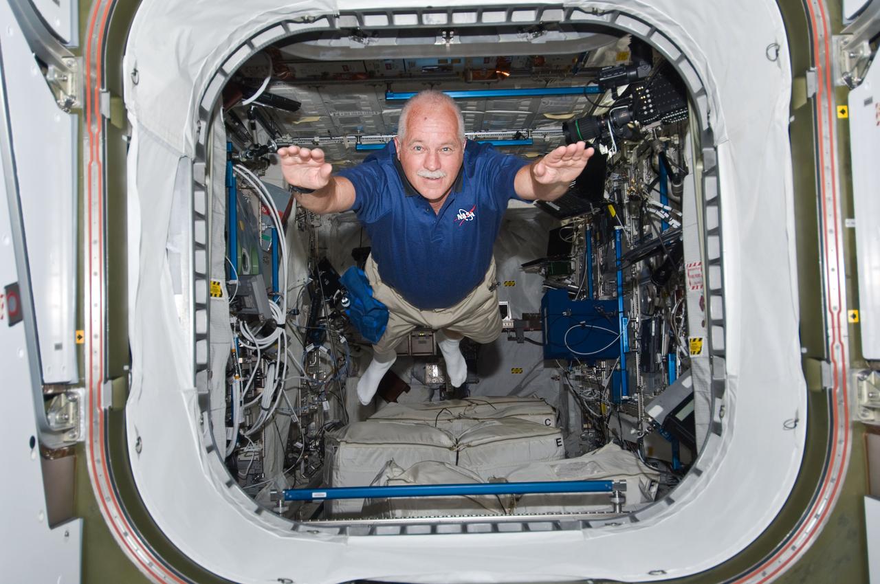 S119-E-006798 (20 March 2009) --- Astronaut John Phillips is about to exit the European Space Agency's Columbus module in a manner quite unique to space travelers. The STS-119 mission specialist and the rest of the Discovery crew are joining forces with the Expedition 18 crew for the continuation of the home improvement project aboard the International Space Station.