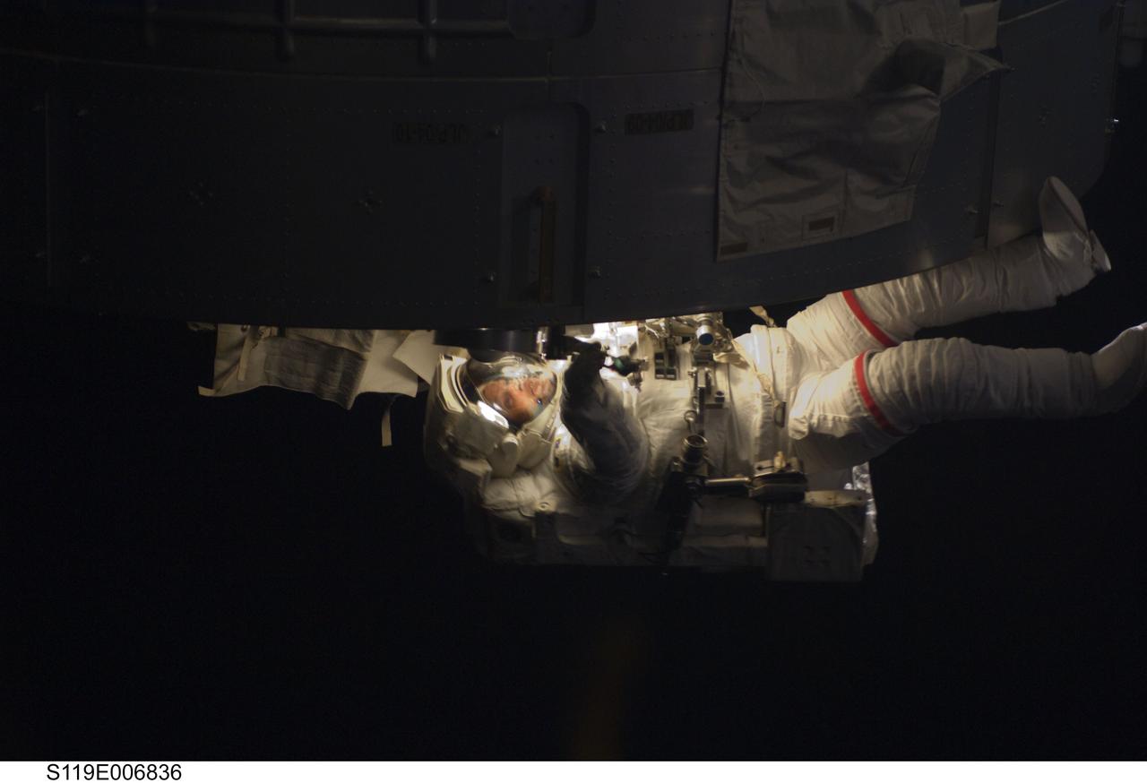 S119-E-006836 (21 March 2009) --- Astronaut Steve Swanson, STS-119 mission specialist, participates in the mission's second scheduled session of extravehicular activity (EVA) as construction and maintenance continue on the International Space Station. During the six-hour, 30-minute spacewalk Swanson and astronaut Joseph Acaba (out of frame), mission specialist, prepared a worksite so the STS-127 spacewalkers can more easily change out the Port 6 truss batteries later this year. On the Japanese Kibo laboratory they installed a second Global Positioning Satellite antenna that will be used for the planned rendezvous of the Japanese HTV cargo ship in September. They photographed areas of radiator panels extended from the Port 1 and Starboard 1 trusses and reconfigured connectors at a patch panel on the Zenith 1 truss that power Control Moment Gyroscopes.