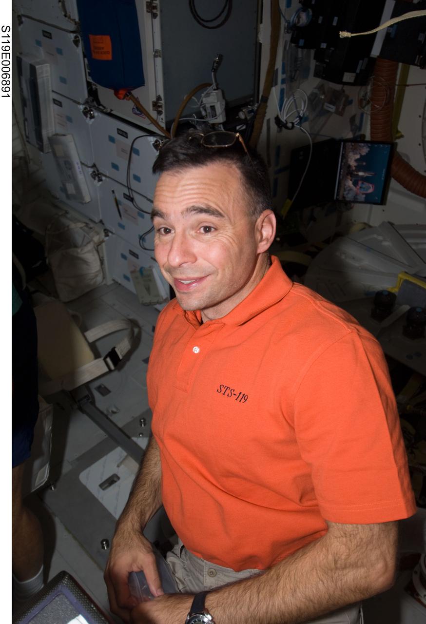S119-E-006891 (21 March 2009) --- Astronaut Lee Archambault, STS-119 commander, is pictured on the middeck of Space Shuttle Discovery while docked with the International Space Station.