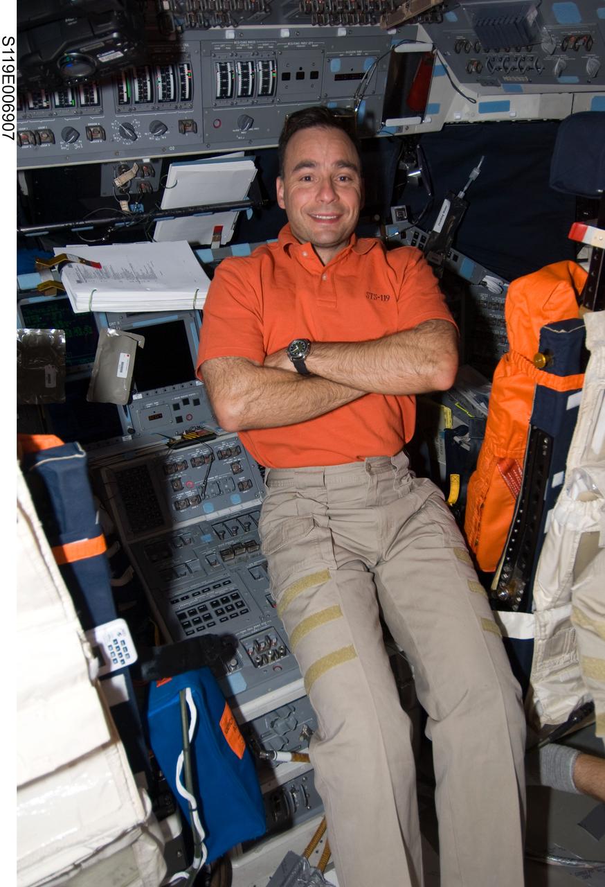 S119-E-006907 (21 March 2009) --- Astronaut Lee Archambault, STS-119 commander, is pictured on the flight deck of Space Shuttle Discovery while docked with the International Space Station.