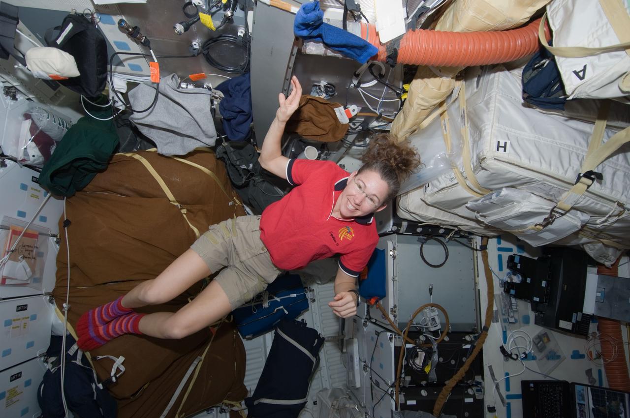 S119-E-006919 (21 March 2009) --- Astronaut Sandra Magnus, STS-119 mission specialist, is pictured on the middeck of Space Shuttle Discovery while docked with the International Space Station.