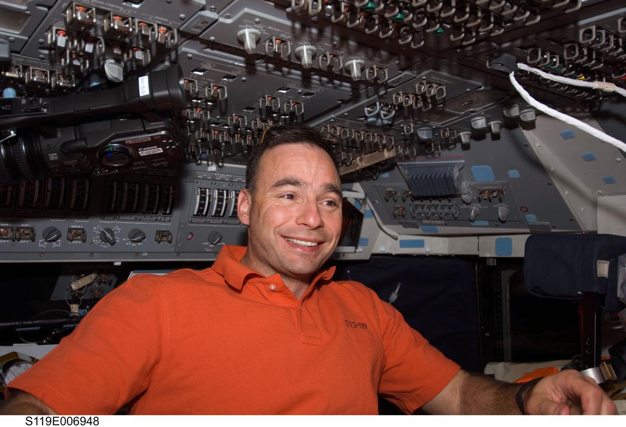 S119-E-006948 (21 March 2009) --- Astronaut Lee Archambault, STS-119 commander, is pictured on the flight deck of Space Shuttle Discovery while docked with the International Space Station.
