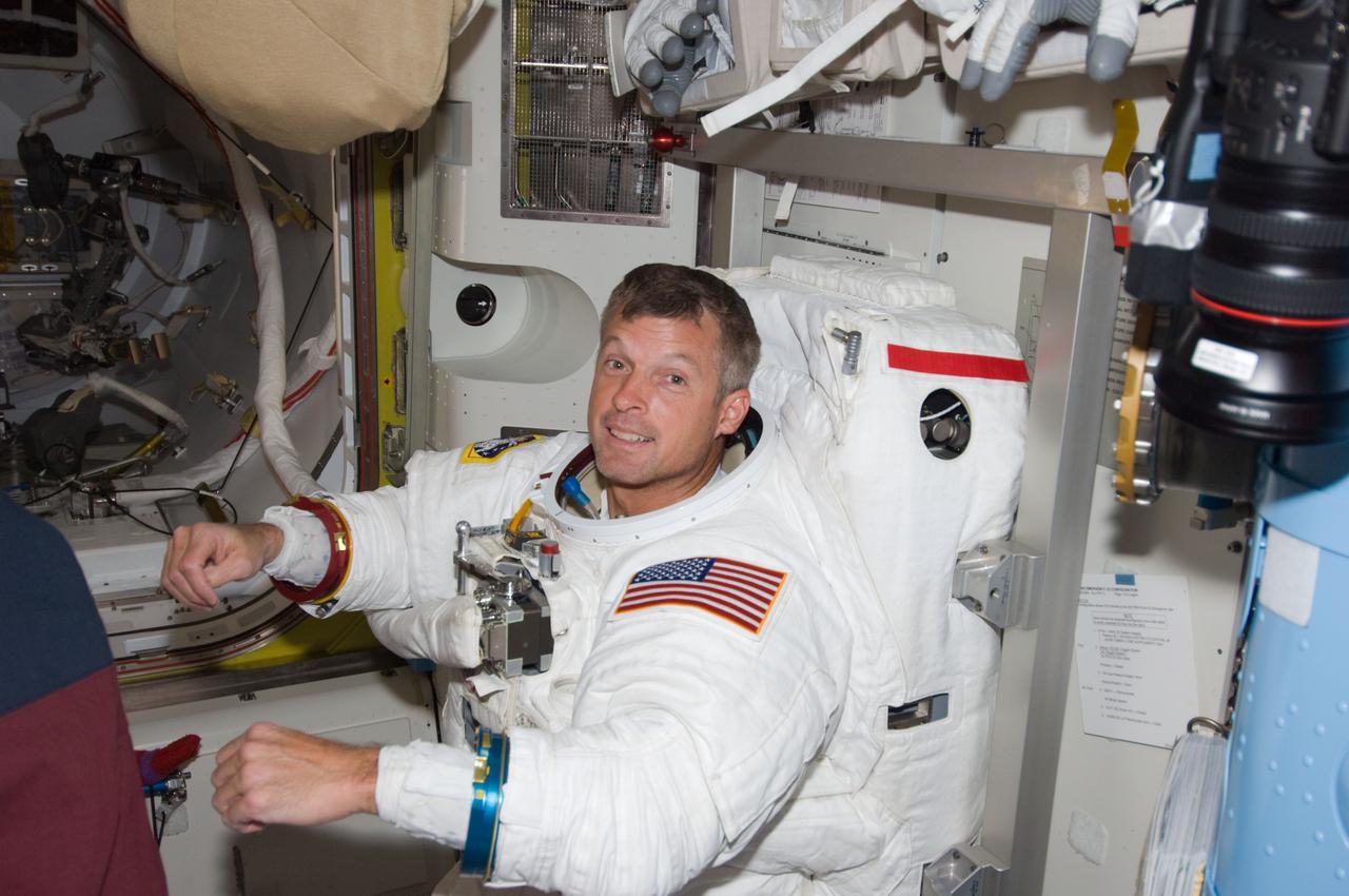S119-E-006970 (21 March 2009) --- Astronaut Steve Swanson, STS-119 mission specialist, attired in his Extravehicular Mobility Unit (EMU) spacesuit, is pictured in the Quest Airlock of the International Space Station as the mission’s second session of extravehicular activity (EVA) draws to a close.