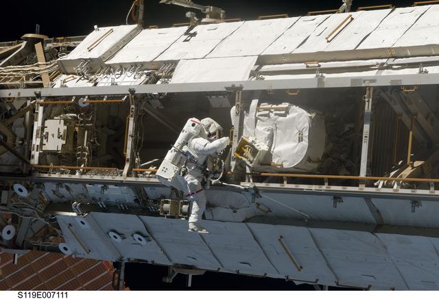 NASA image: STS-119 EVA 3 GAT S1 Truss  Flex Hose Rotary Coupler (FHRC) P-Clamp Release