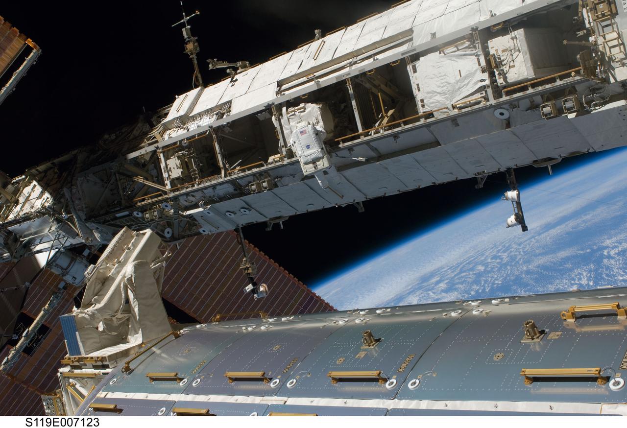 S119-E-007123 (23 March 2009) --- Astronaut Joseph Acaba, STS-119 mission specialist, participates in the mission's third scheduled session of extravehicular activity (EVA) as construction and maintenance continue on the International Space Station. During the six-hour, 27-minute spacewalk, Acaba and Richard Arnold (out of frame), mission specialist, helped robotic arm operators relocate the Crew Equipment Translation Aid (CETA) cart from the Port 1 to Starboard 1 truss segment, installed a new coupler on the CETA cart, lubricated snares on the "B" end of the space station's robotic arm and performed a few "get ahead" tasks.