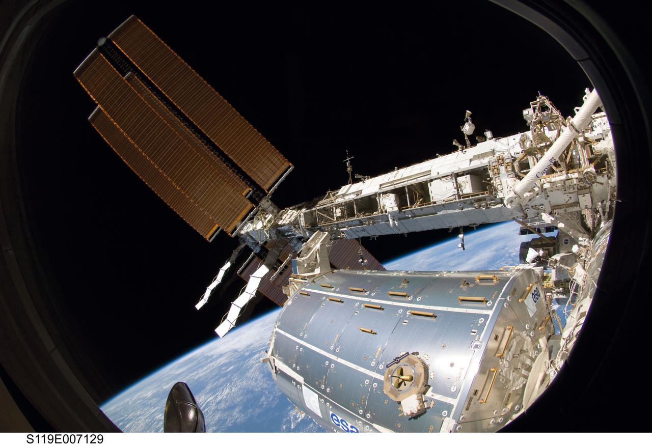 S119-E-007129 (23 March 2009) --- Astronaut Joseph Acaba, STS-119 mission specialist, participates in the mission's third scheduled session of extravehicular activity (EVA) as construction and maintenance continue on the International Space Station. During the six-hour, 27-minute spacewalk, Acaba and Richard Arnold (out of frame), mission specialist, helped robotic arm operators relocate the Crew Equipment Translation Aid (CETA) cart from the Port 1 to Starboard 1 truss segment, installed a new coupler on the CETA cart, lubricated snares on the "B" end of the space station's robotic arm and performed a few "get ahead" tasks.