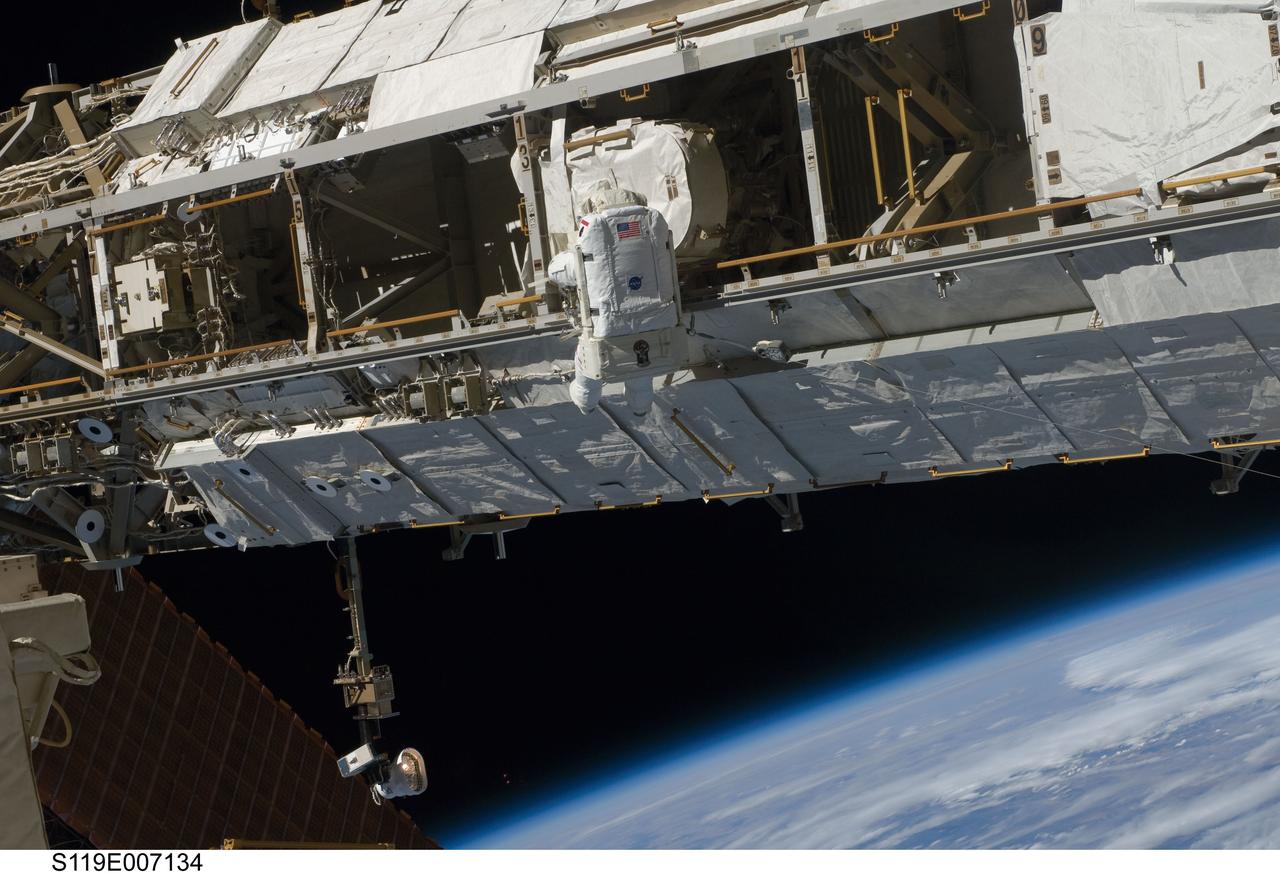 S119-E-007134 (23 March 2009) --- Astronaut Joseph Acaba, STS-119 mission specialist, participates in the mission's third scheduled session of extravehicular activity (EVA) as construction and maintenance continue on the International Space Station. During the six-hour, 27-minute spacewalk, Acaba and Richard Arnold (out of frame), mission specialist, helped robotic arm operators relocate the Crew Equipment Translation Aid (CETA) cart from the Port 1 to Starboard 1 truss segment, installed a new coupler on the CETA cart, lubricated snares on the "B" end of the space station's robotic arm and performed a few "get ahead" tasks.