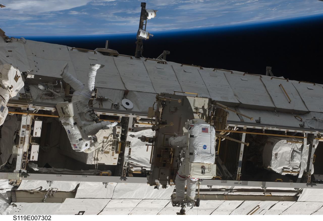S119-E-007302 (23 March 2009) --- Astronauts Richard Arnold (left) and Joseph Acaba, both STS-119 mission specialists, participate in the mission's third scheduled session of extravehicular activity (EVA) as construction and maintenance continue on the International Space Station. During the six-hour, 27-minute spacewalk, Arnold and Acaba helped robotic arm operators relocate the Crew Equipment Translation Aid (CETA) cart from the Port 1 to Starboard 1 truss segment, installed a new coupler on the CETA cart, lubricated snares on the "B" end of the space station's robotic arm and performed a few "get ahead" tasks.
