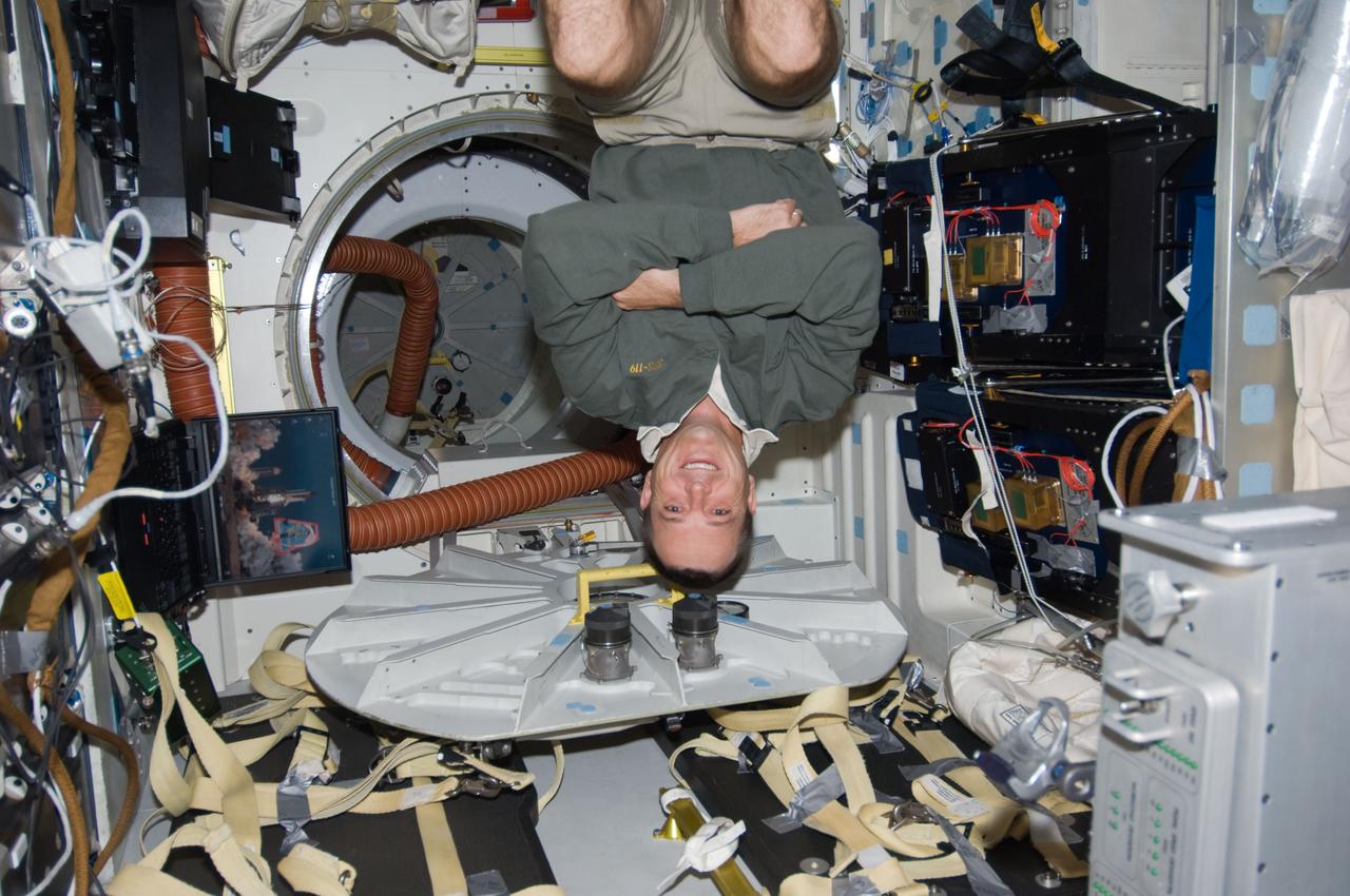 S119-E-007491 (22 March 2009) --- Astronaut Richard Arnold, STS-119 mission specialist, floats on the middeck of Space Shuttle Discovery while docked with the International Space Station.