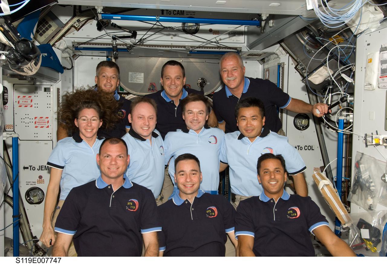 S119-E-007747 (24 March 2009) --- STS-119 and Expedition 18 crewmembers pose for a group photo following a joint news conference in the Harmony node of the International Space Station while Space Shuttle Discovery remains docked with the station. From the left (bottom row) are NASA astronauts Tony Antonelli, STS-119 pilot; Lee Archambault, STS-119 commander; and Joseph Acaba, STS-119 mission specialist. From the left (middle row) are NASA astronauts Sandra Magnus, STS-119 mission specialist; and Michael Fincke, Expedition 18 commander; along with cosmonaut Yury Lonchakov and Japan Aerospace Exploration Agency astronaut (JAXA) Koichi Wakata, both Expedition 18 flight engineers. From the left (top row) are NASA astronauts Steve Swanson, Richard Arnold and John Phillips, all STS-119 mission specialists. Magnus, who joined the station’s Expedition 18 crew in November 2008, is being replaced by Wakata, who arrived at the station with the STS-119 crew.