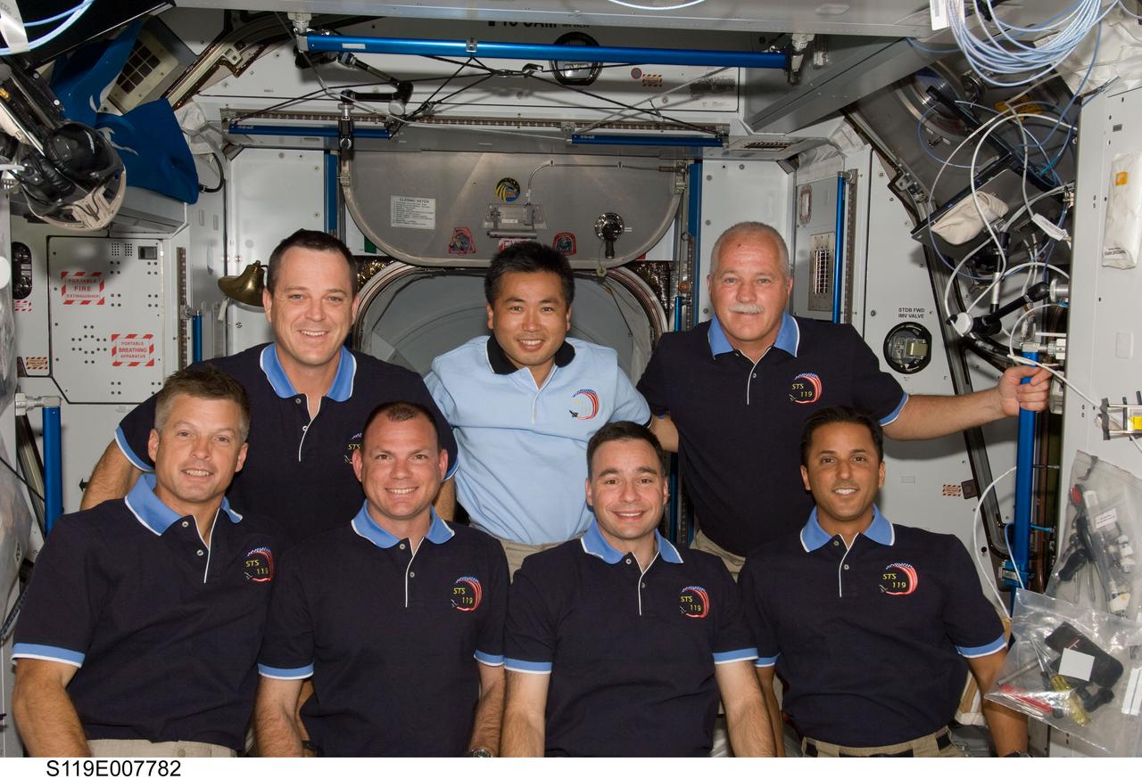 S119-E-007782 (24 March 2009) --- STS-119 crewmembers and Japan Aerospace Exploration Agency astronaut (JAXA) Koichi Wakata (center, top row), Expedition 18 flight engineer, pose for a group photo following a joint news conference with the Expedition 18 crewmembers from the Harmony node of the International Space Station while Space Shuttle Discovery remains docked with the station. Also pictured from the left (bottom row) are NASA astronauts Steve Swanson, mission specialist; Tony Antonelli, pilot; Lee Archambault, commander; and Joseph Acaba, mission specialist. Pictured on the top row with Wakata are astronauts Richard Arnold (left) and John Phillips, both mission specialists. NASA astronaut Sandra Magnus (not pictured), who joined the station’s crew in November, is being replaced by Wakata, who arrived at the station with the STS-119 crew.