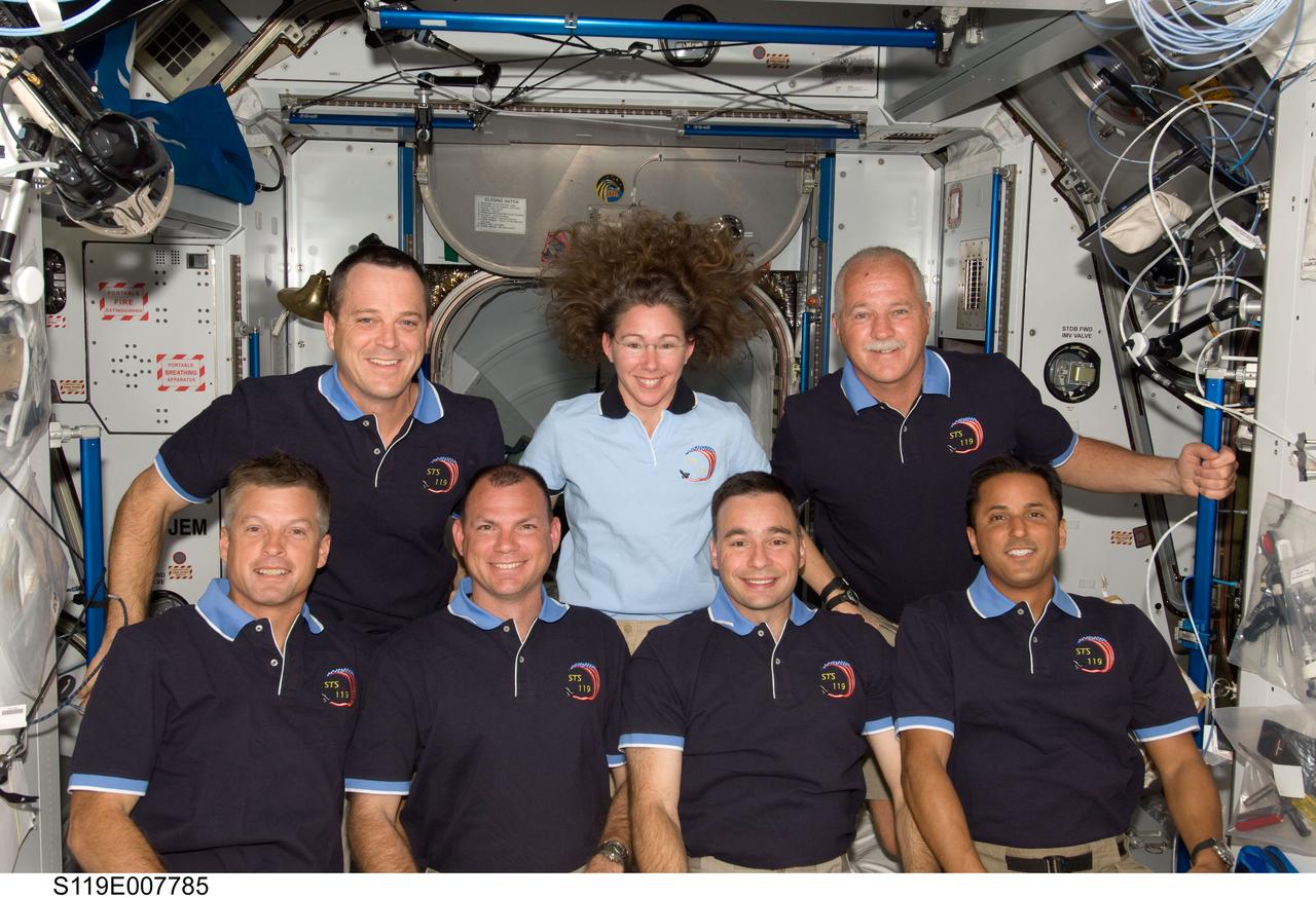S119-E-007785 (24 March 2009) --- STS-119 crewmembers and astronaut Sandra Magnus (center, top row), Expedition 18 flight engineer, pose for a group photo following a joint news conference with the Expedition 18 crewmembers from the Harmony node of the International Space Station while Space Shuttle Discovery remains docked with the station. Also pictured from the left (bottom row) are NASA astronauts Steve Swanson, mission specialist; Tony Antonelli, pilot; Lee Archambault, commander; and Joseph Acaba, mission specialist. Pictured on the top row with Magnus are astronauts Richard Arnold (left) and John Phillips, both mission specialists. Magnus, who joined the station’s crew in November, is being replaced by Japan Aerospace Exploration Agency astronaut (JAXA) Koichi Wakata (not pictured), who arrived at the station with the STS-119 crew.