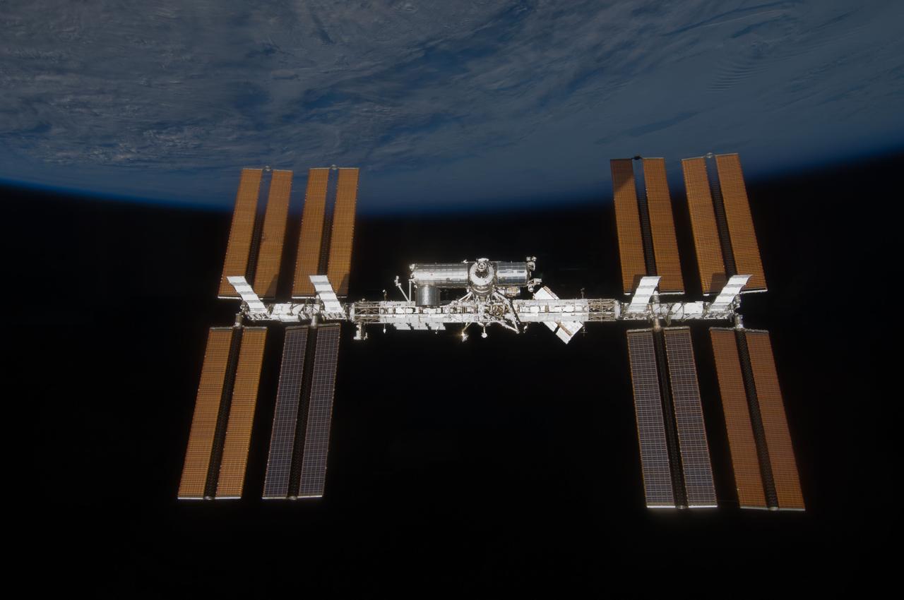S119-E-008308 (25 March 2009) --- Backdropped by the blackness of space and Earth’s horizon, the International Space Station is seen from Space Shuttle Discovery as the two spacecraft begin their relative separation. Earlier the STS-119 and Expedition 18 crews concluded 9 days, 20 hours and 10 minutes of cooperative work onboard the shuttle and station. Undocking of the two spacecraft occurred at 2:53 p.m. (CDT) on March 25, 2009.