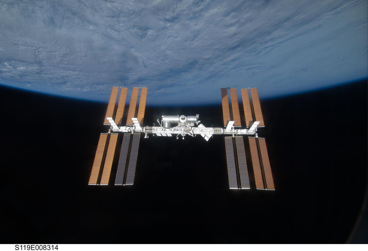S119-E-008314 (25 March 2009) --- Backdropped by the blackness of space and Earth’s horizon, the International Space Station is seen from Space Shuttle Discovery as the two spacecraft begin their relative separation. Earlier the STS-119 and Expedition 18 crews concluded 9 days, 20 hours and 10 minutes of cooperative work onboard the shuttle and station. Undocking of the two spacecraft occurred at 2:53 p.m. (CDT) on March 25, 2009.