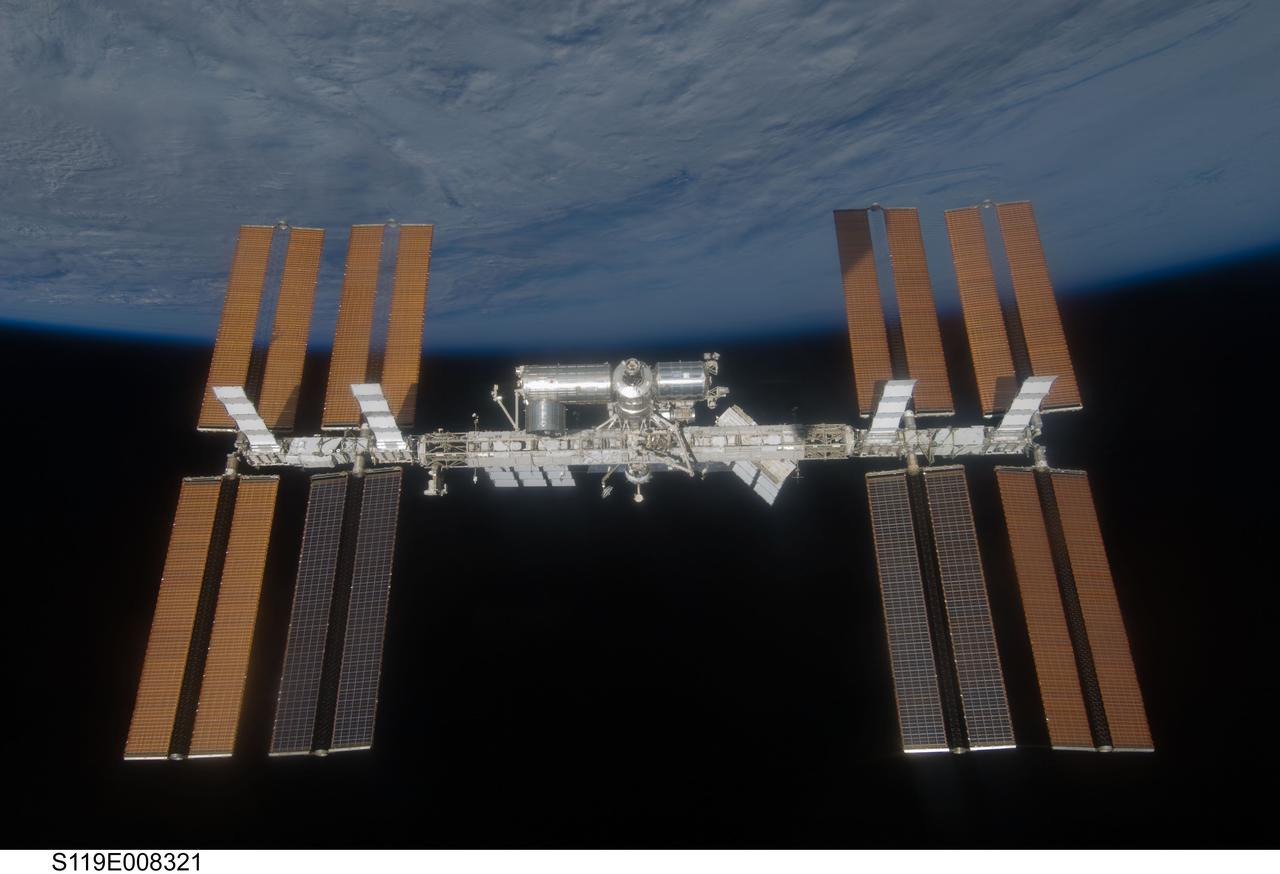 S119-E-008321 (25 March 2009) --- Backdropped by the blackness of space and Earth’s horizon, the International Space Station is seen from Space Shuttle Discovery as the two spacecraft begin their relative separation. Earlier the STS-119 and Expedition 18 crews concluded 9 days, 20 hours and 10 minutes of cooperative work onboard the shuttle and station. Undocking of the two spacecraft occurred at 2:53 p.m. (CDT) on March 25, 2009.