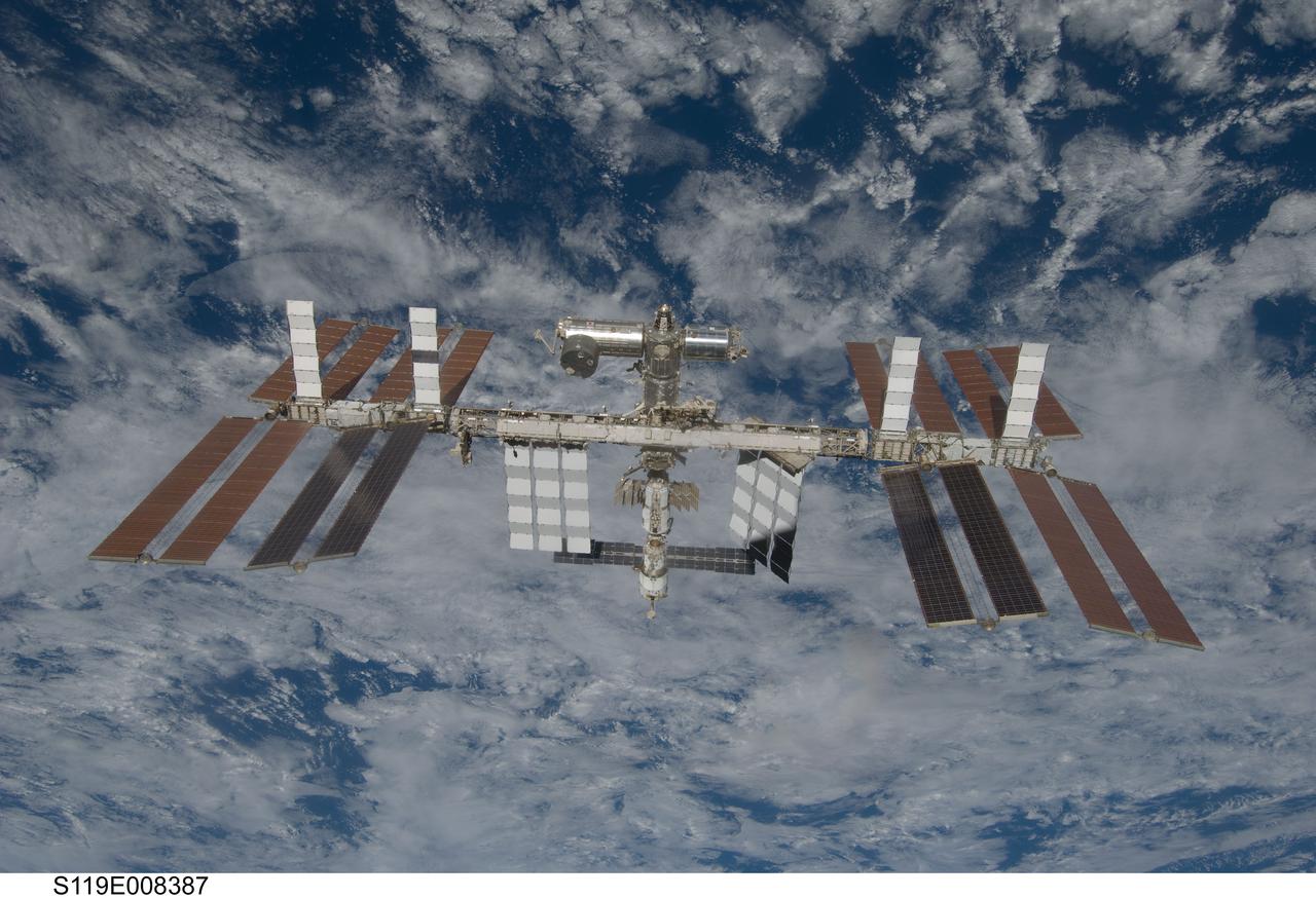 S119-E-008387 (25 March 2009) --- Backdropped by a blue and white Earth, the International Space Station is seen from Space Shuttle Discovery as the two spacecraft begin their relative separation. Earlier the STS-119 and Expedition 18 crews concluded 9 days, 20 hours and 10 minutes of cooperative work onboard the shuttle and station. Undocking of the two spacecraft occurred at 2:53 p.m. (CDT) on March 25, 2009.