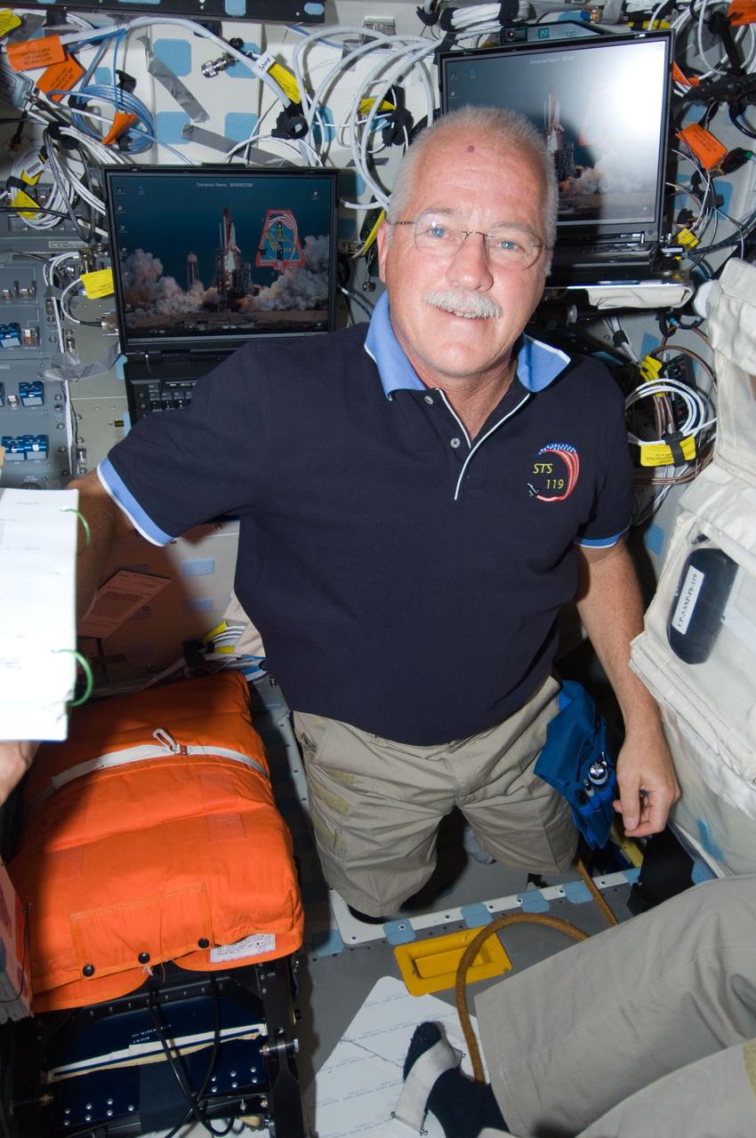 S119-E-008472 (25 March 2009) --- Astronaut John Phillips, STS-119 mission specialist, is pictured on the middeck of Space Shuttle Discovery during flight day 11 activities.
