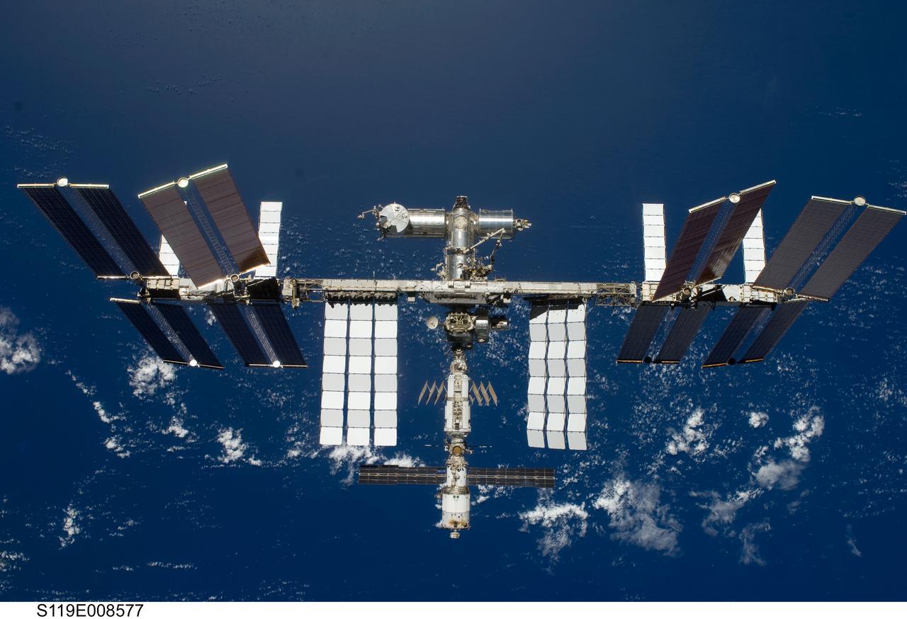 S119-E-008577 (25 March 2009) --- Backdropped by a blue and white Earth, the International Space Station is seen from Space Shuttle Discovery as the two spacecraft begin their relative separation. Earlier the STS-119 and Expedition 18 crews concluded 9 days, 20 hours and 10 minutes of cooperative work onboard the shuttle and station. Undocking of the two spacecraft occurred at 2:53 p.m. (CDT) on March 25, 2009.