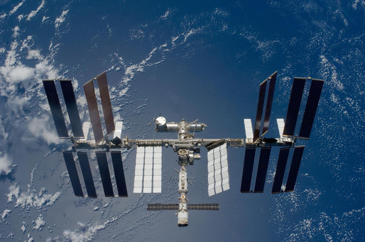 S119-E-008594 (25 March 2009) --- Backdropped by a blue and white Earth, the International Space Station is seen from Space Shuttle Discovery as the two spacecraft begin their relative separation. Earlier the STS-119 and Expedition 18 crews concluded 9 days, 20 hours and 10 minutes of cooperative work onboard the shuttle and station. Undocking of the two spacecraft occurred at 2:53 p.m. (CDT) on March 25, 2009.
