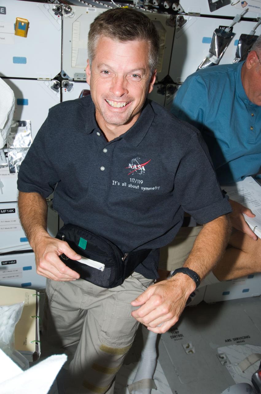 S119-E-010129 (26 March 2009) --- Astronaut Steve Swanson, STS-119 mission specialist, is pictured on the middeck of Space Shuttle Discovery during flight day 12 activities.