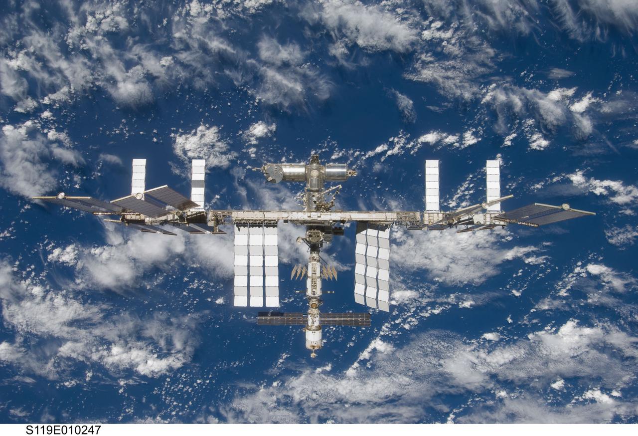 S119-E-010247 (25 March 2009) --- Backdropped by a blue and white Earth, the International Space Station is seen from Space Shuttle Discovery as the two spacecraft begin their relative separation. Earlier the STS-119 and Expedition 18 crews concluded 9 days, 20 hours and 10 minutes of cooperative work onboard the shuttle and station. Undocking of the two spacecraft occurred at 2:53 p.m. (CDT) on March 25, 2009.