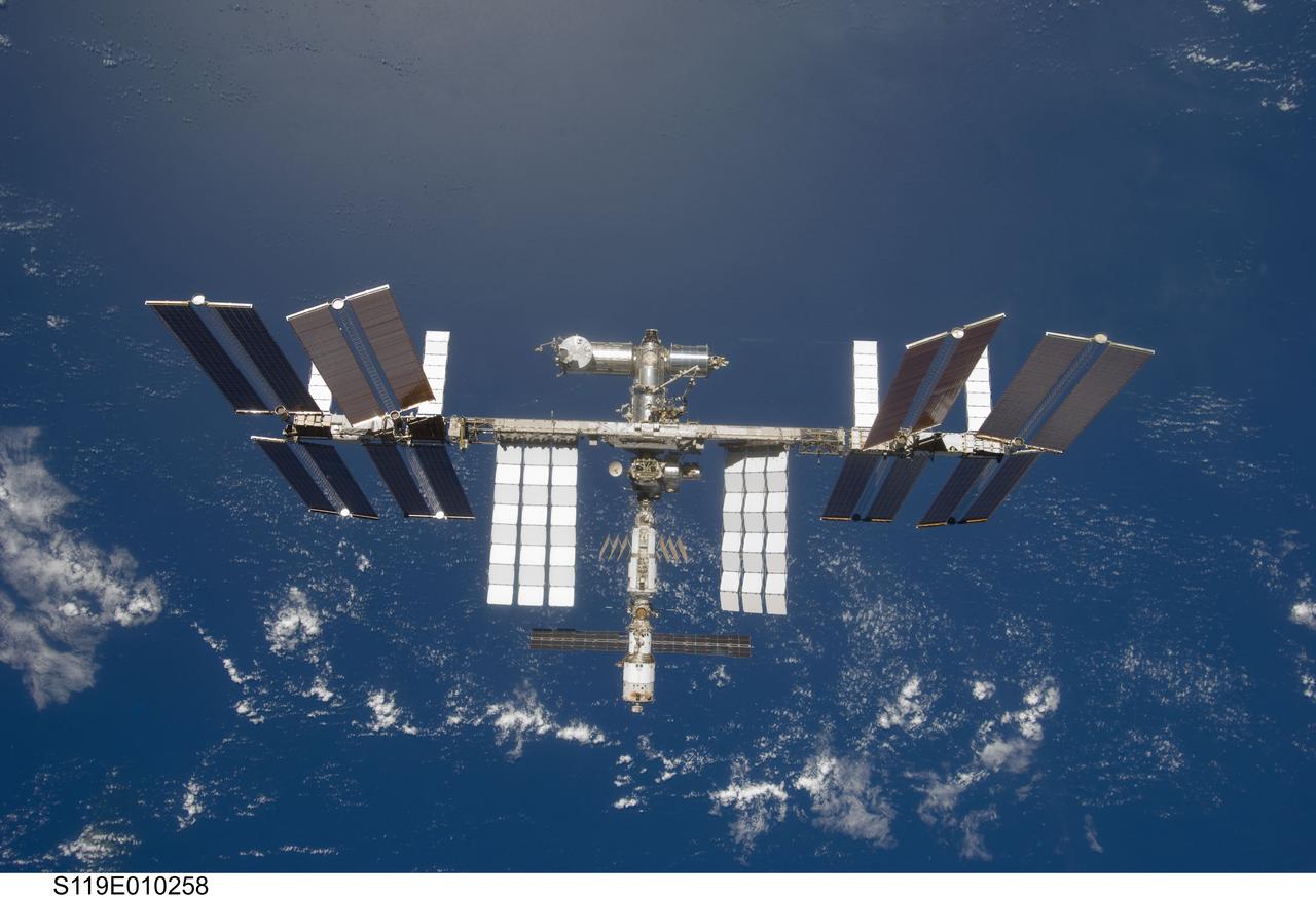 S119-E-010258 (25 March 2009) --- Backdropped by a blue and white Earth, the International Space Station is seen from Space Shuttle Discovery as the two spacecraft begin their relative separation. Earlier the STS-119 and Expedition 18 crews concluded 9 days, 20 hours and 10 minutes of cooperative work onboard the shuttle and station. Undocking of the two spacecraft occurred at 2:53 p.m. (CDT) on March 25, 2009.