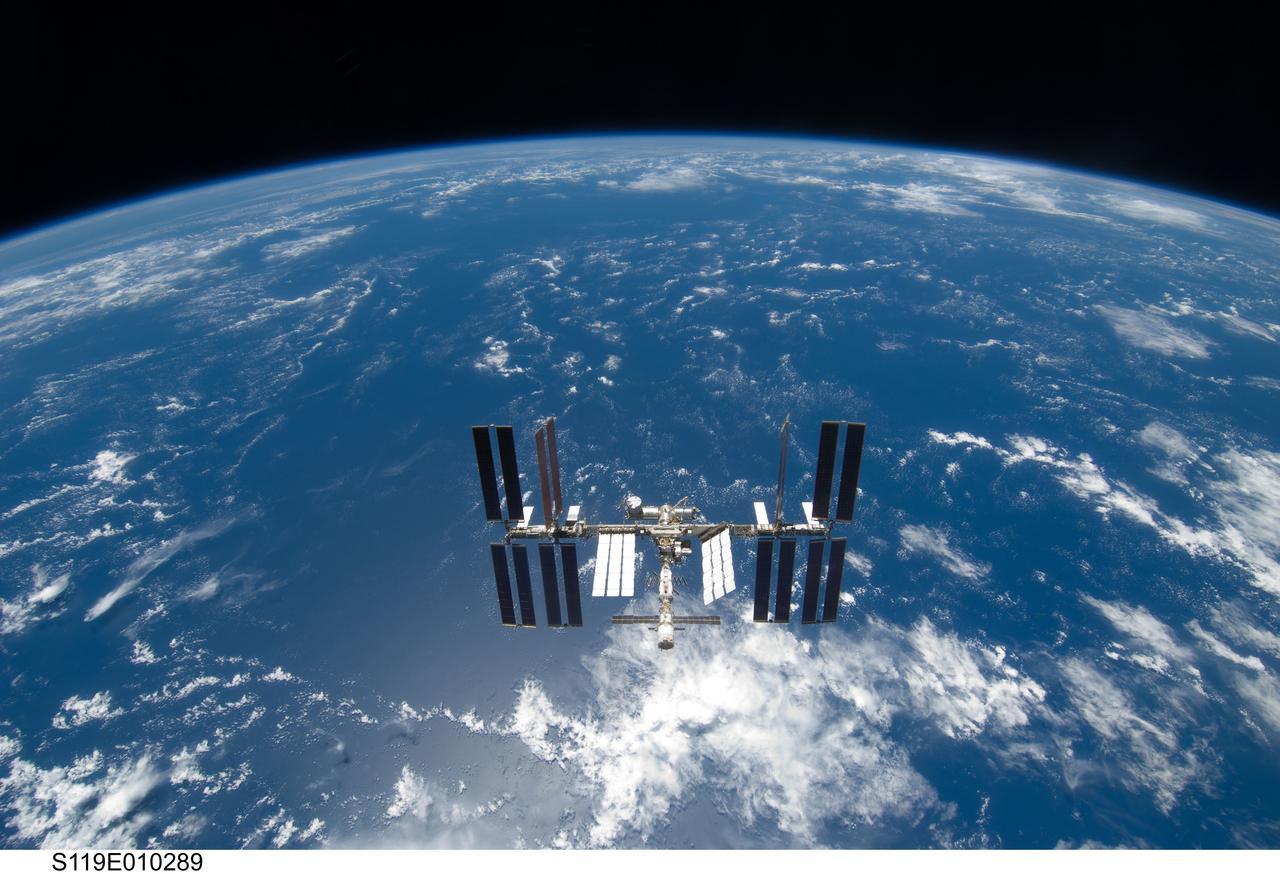S119-E-010289 (25 March 2009) --- Backdropped by a blue and white Earth, the International Space Station is seen from Space Shuttle Discovery as the two spacecraft begin their relative separation. Earlier the STS-119 and Expedition 18 crews concluded 9 days, 20 hours and 10 minutes of cooperative work onboard the shuttle and station. Undocking of the two spacecraft occurred at 2:53 p.m. (CDT) on March 25, 2009.
