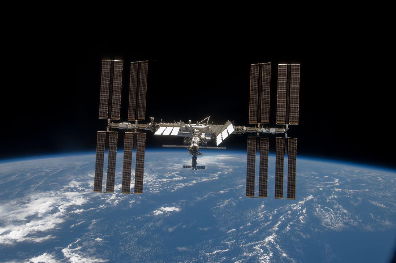 S119-E-010316 (25 March 2009) --- Backdropped by the blackness of space and Earth?s horizon, the International Space Station is seen from Space Shuttle Discovery as the two spacecraft begin their relative separation. Earlier the STS-119 and Expedition 18 crews concluded 9 days, 20 hours and 10 minutes of cooperative work onboard the shuttle and station. Undocking of the two spacecraft occurred at 2:53 p.m. (CDT) on March 25, 2009.