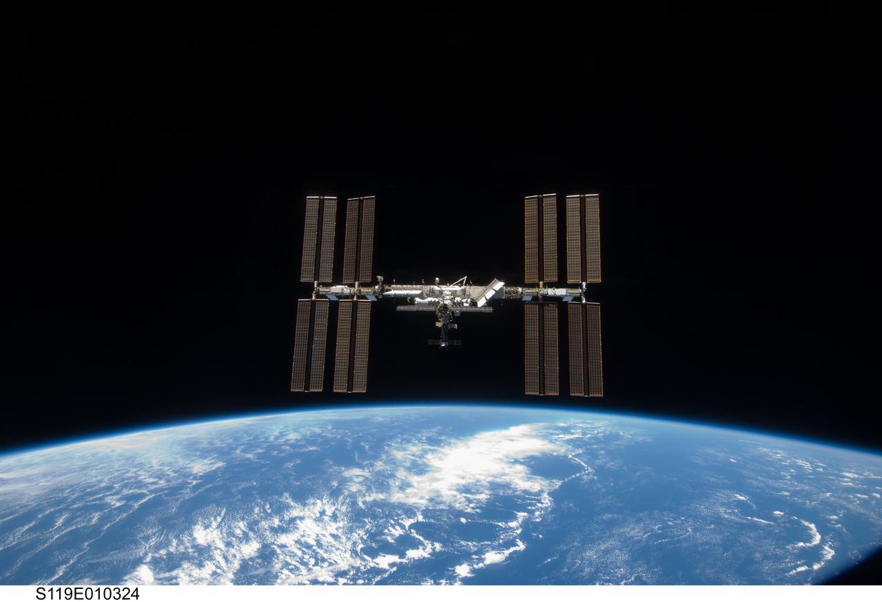 S119-E-010324 (25 March 2009) --- Backdropped by the blackness of space and Earth?s horizon, the International Space Station is seen from Space Shuttle Discovery as the two spacecraft begin their relative separation. Earlier the STS-119 and Expedition 18 crews concluded 9 days, 20 hours and 10 minutes of cooperative work onboard the shuttle and station. Undocking of the two spacecraft occurred at 2:53 p.m. (CDT) on March 25, 2009.