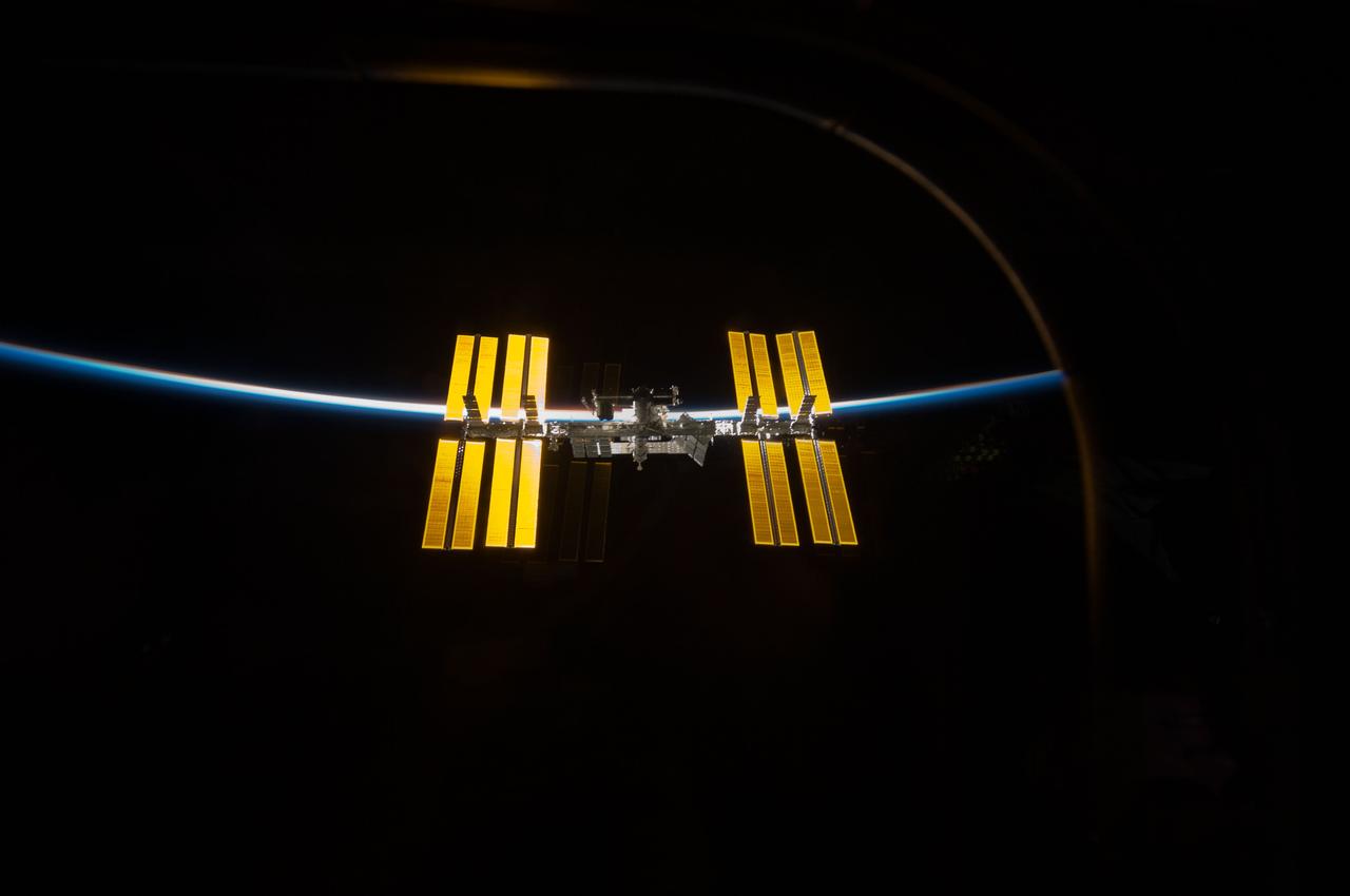 S119-E-010506 (25 March 2009) --- Backdropped by the blackness of space and the thin line of Earth?s atmosphere, the International Space Station is seen from Space Shuttle Discovery as the two spacecraft begin their relative separation. Earlier the STS-119 and Expedition 18 crews concluded 9 days, 20 hours and 10 minutes of cooperative work onboard the shuttle and station. Undocking of the two spacecraft occurred at 2:53 p.m. (CDT) on March 25, 2009.