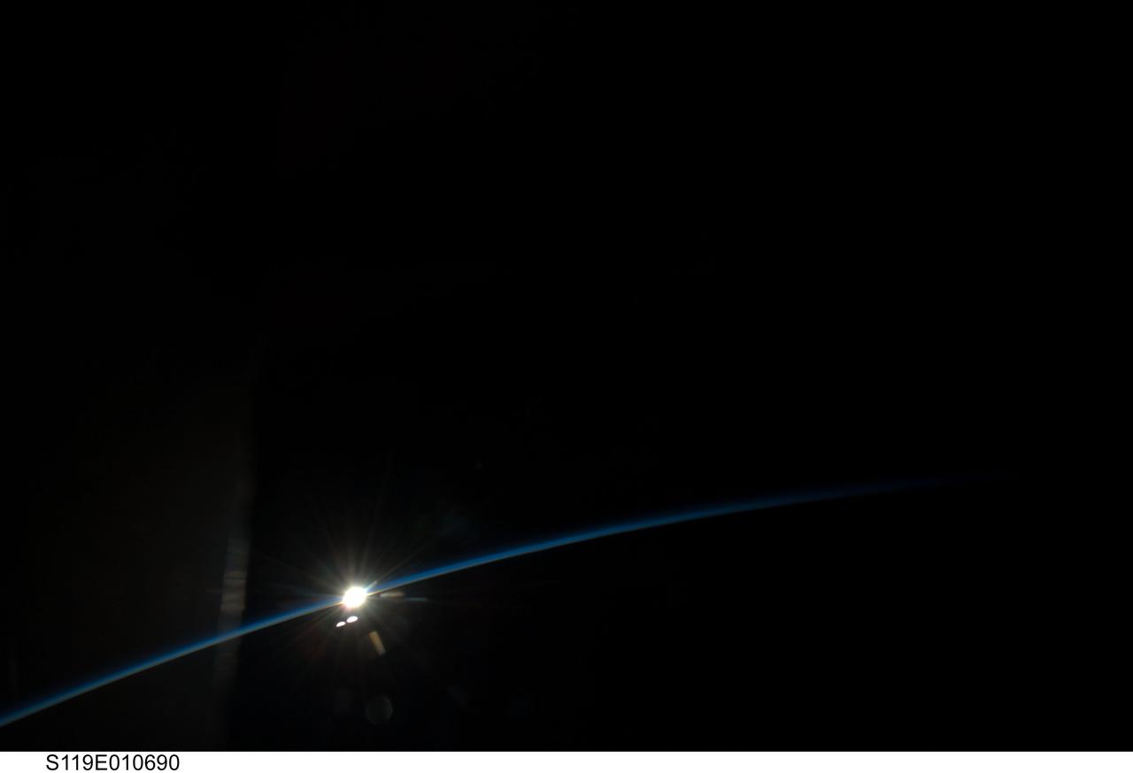 S119-E-010690 (27 March 2009) --- On its final full day in space before a scheduled return home on March 28, the crew of Space Shuttle Discovery took some pictures of the home planet. Unlike most of the images, which showed closer views of Earth featuring oceans, lakes, rivers, clouds, mountains and deserts, this view shows Earth's limb as the spacecraft approached a rising or setting sun.