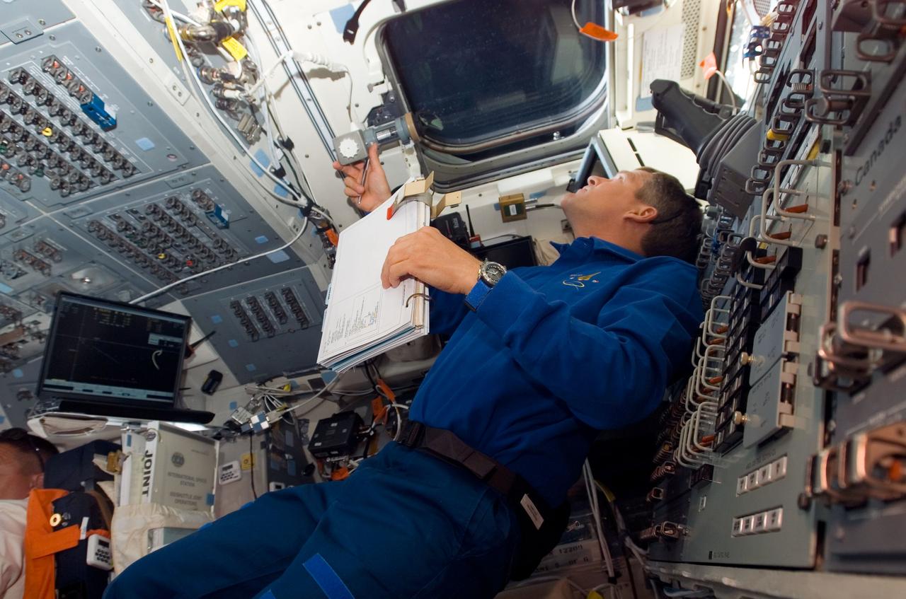 S120-E-006219 (25 Oct. 2007) --- Astronaut Scott Parazynski, STS-120 mission specialist, looks out an overhead window on the aft flight deck of Space Shuttle Discovery during flight day three activities.