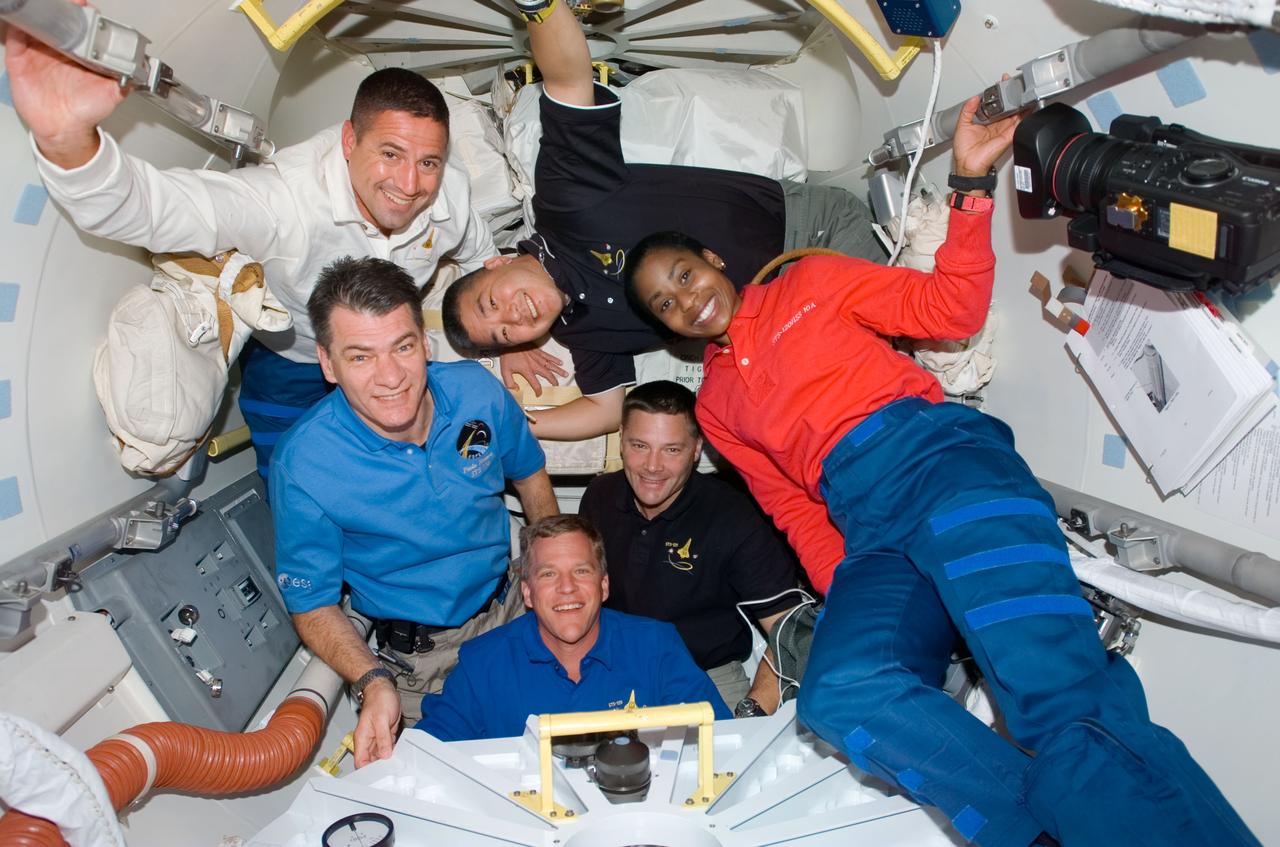 S120-E-006402 (25 Oct. 2007) --- STS-120 crewmembers gather in the Orbiter Docking Compartment (ODS) after hatch opening between the International Space Station and Space Shuttle Discovery. Pictured (clockwise) are astronauts George Zamka (white shirt), pilot; Daniel Tani, Stephanie Wilson, Doug Wheelock, Scott Parazynski and European Space Agency's (ESA) Paolo Nespoli, all mission specialists. Astronaut Pam Melroy, commander, is out of frame.