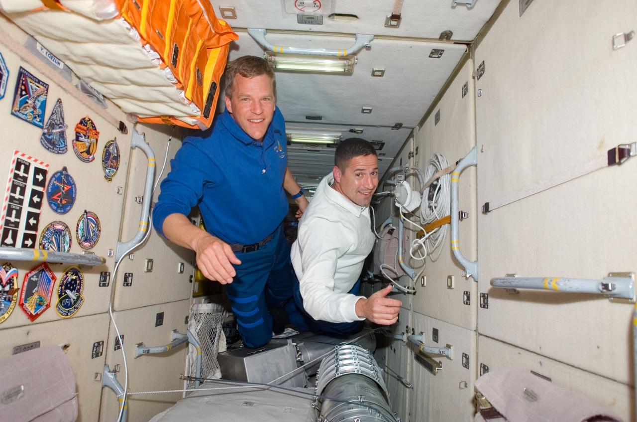 S120-E-006416 (25 Oct. 2007) --- Astronauts Scott Parazynski (left) and George Zamka, STS-120 mission specialist and pilot, respectively, float in the Zarya module of the International Space Station while Space Shuttle Discovery is docked with the station.