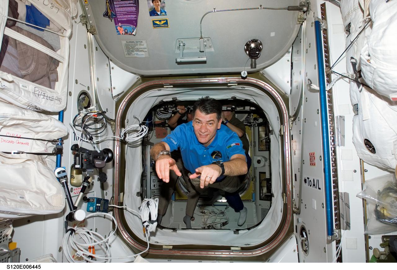 S120-E-006445 (25 Oct. 2007) --- European Space Agency (ESA) astronaut Paolo Nespoli, STS-120 mission specialist, floats through an airlock hatch on the International Space Station while Space Shuttle Discovery is docked with the station.