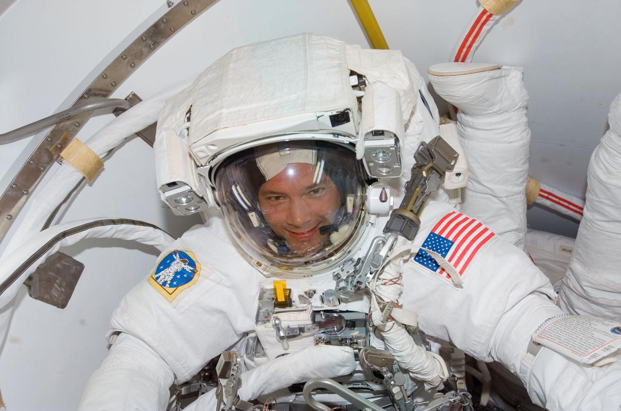 S120-E-006859 (26 Oct. 2007) --- Astronaut Doug Wheelock shares the airlock with astronaut Scott Parazynski, as the two mission specialists prepare for their Oct. 26 spacewalk, the first of five scheduled by various shuttle and International Space Station crewmembers while the Space Shuttle Discovery is docked to ISS.