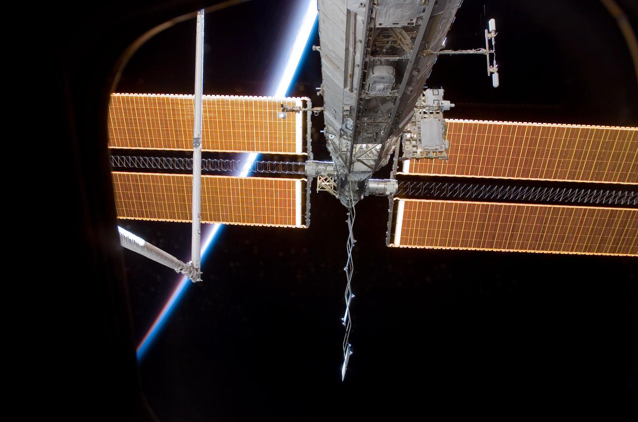 S120-E-006867 (26 Oct. 2007) --- Airglow above Earth's horizon and solar array panels add color to this scene of a portion of the International Space Station as the orbiting complex is docked with the Space Shuttle Discovery while crewmembers aboard the two spacecraft share more than a week's worth of duties to perform important work on the ISS.