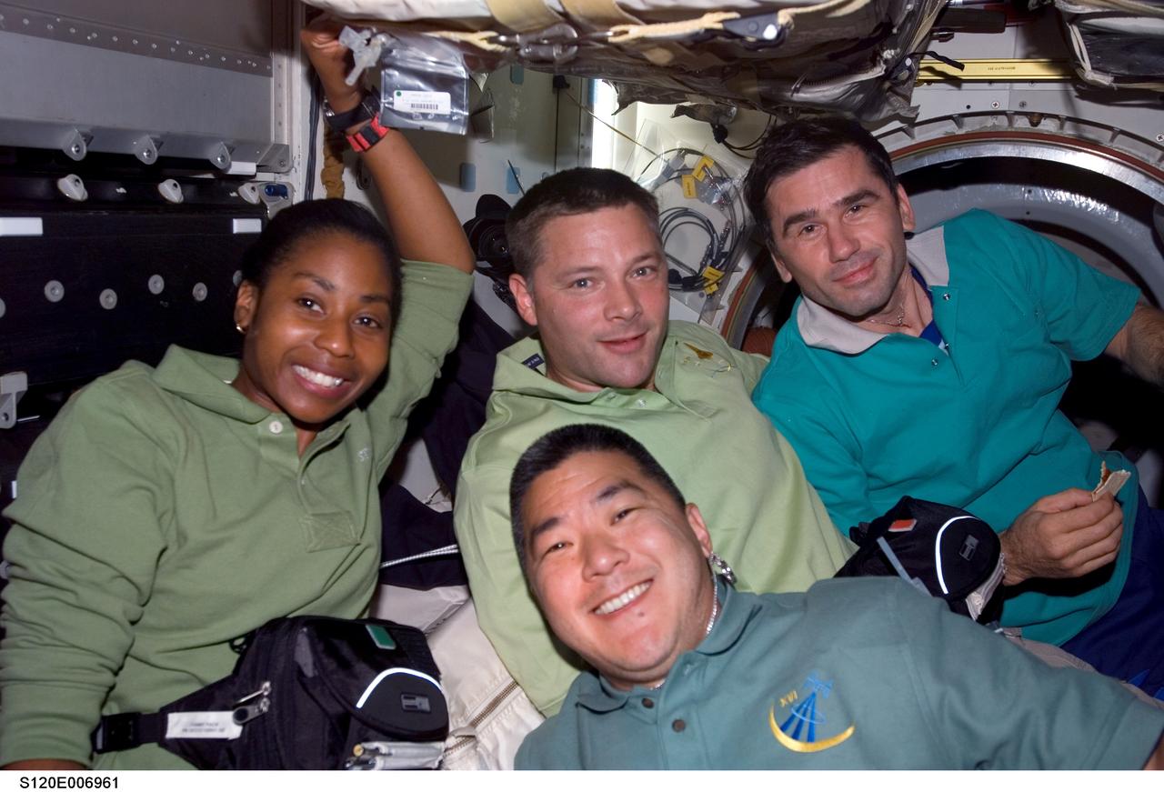 S120-E-006961 (27 Oct. 2007) --- Astronauts Daniel Tani (bottom), Expedition 16 flight engineer; Stephanie Wilson and Doug Wheelock (center), both STS-120 mission specialists; and cosmonaut Yuri I. Malenchenko, flight engineer representing Russia's Federal Space Agency, take a moment for a photo on the middeck of Space Shuttle Discovery while docked with the International Space Station.