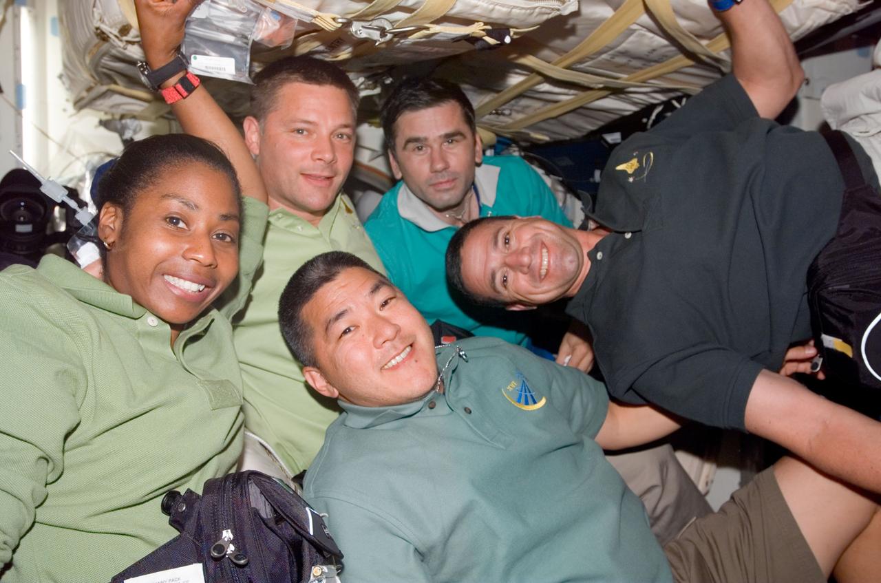 S120-E-006963 (27 Oct. 2007) --- Astronauts Daniel Tani (bottom), Expedition 16 flight engineer; Stephanie Wilson, and Doug Wheelock (second left), both STS-120 mission specialists; cosmonaut Yuri I. Malenchenko, flight engineer representing Russia's Federal Space Agency; and astronaut George Zamka (right), STS-120 pilot, take a moment for a photo on the middeck of Space Shuttle Discovery while docked with the International Space Station.