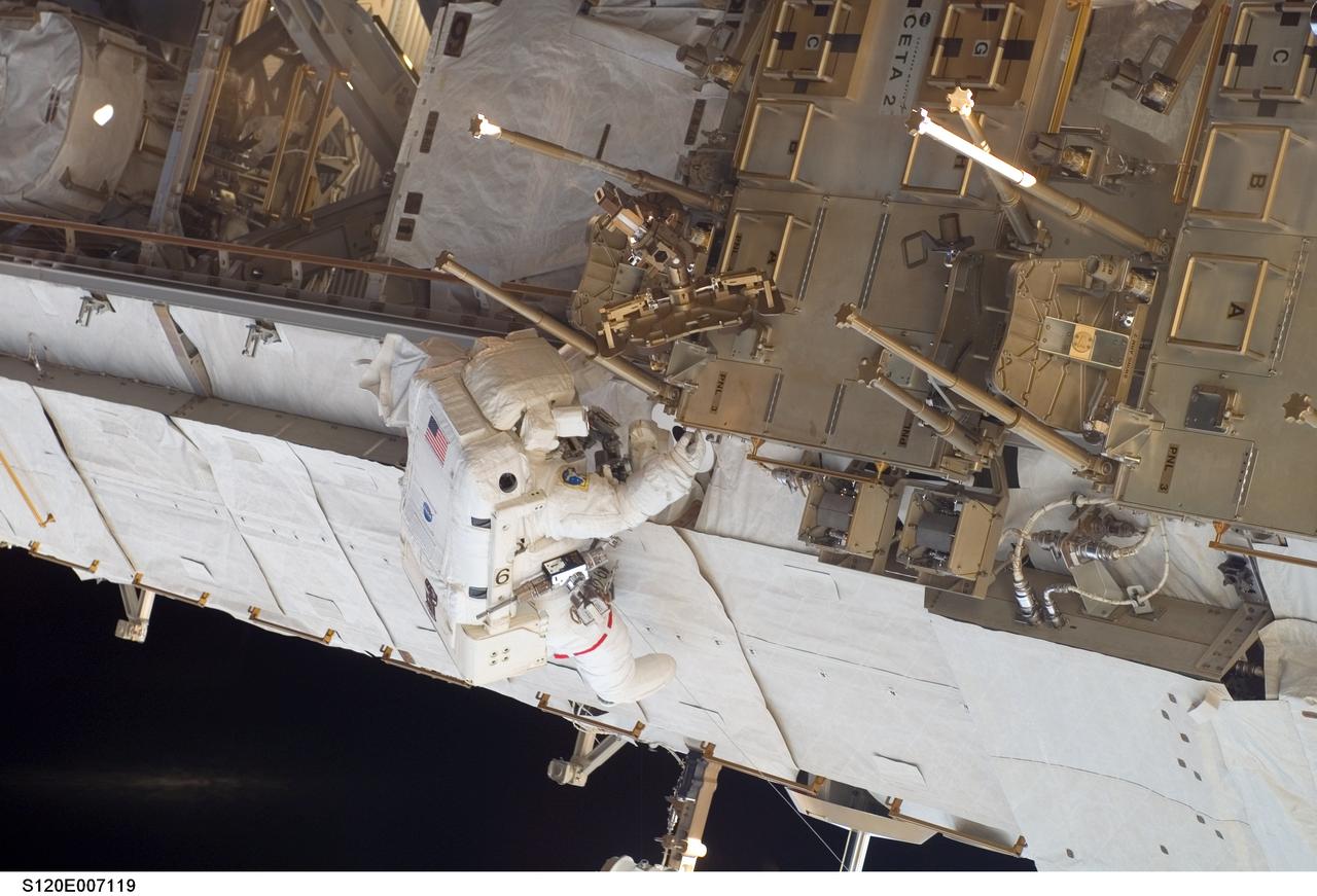 S120-E-007119 (28 Oct. 2007) --- Astronaut Daniel Tani, Expedition 16 flight engineer, participates in the second of five scheduled sessions of extravehicular activity (EVA) as construction continues on the International Space Station. During the 6-hour, 33-minute spacewalk Tani and astronaut Scott Parazynski (out of frame), STS-120 mission specialist, worked in tandem to disconnect cables from the P6 truss, allowing it to be removed from the Z1 truss. Tani also visually inspected the station's starboard Solar Alpha Rotary Joint (SARJ) and gathered samples of "shavings" he found under the joint's multi-layer insulation covers. Also the spacewalkers outfitted the Harmony module, mated the power and data grapple fixture and reconfigured connectors on the starboard 1 (S1) truss that will allow the radiator on S1 to be deployed from the ground later.