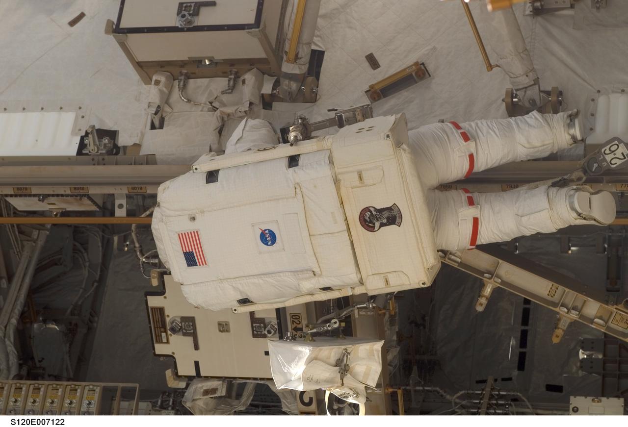 S120-E-007122 (28 Oct. 2007) --- Astronaut Daniel Tani, Expedition 16 flight engineer, participates in the second of five scheduled sessions of extravehicular activity (EVA) as construction continues on the International Space Station. During the 6-hour, 33-minute spacewalk Tani and astronaut Scott Parazynski (out of frame), STS-120 mission specialist, worked in tandem to disconnect cables from the P6 truss, allowing it to be removed from the Z1 truss. Tani also visually inspected the station's starboard Solar Alpha Rotary Joint (SARJ) and gathered samples of "shavings" he found under the joint's multi-layer insulation covers. Also the spacewalkers outfitted the Harmony module, mated the power and data grapple fixture and reconfigured connectors on the starboard 1 (S1) truss that will allow the radiator on S1 to be deployed from the ground later.